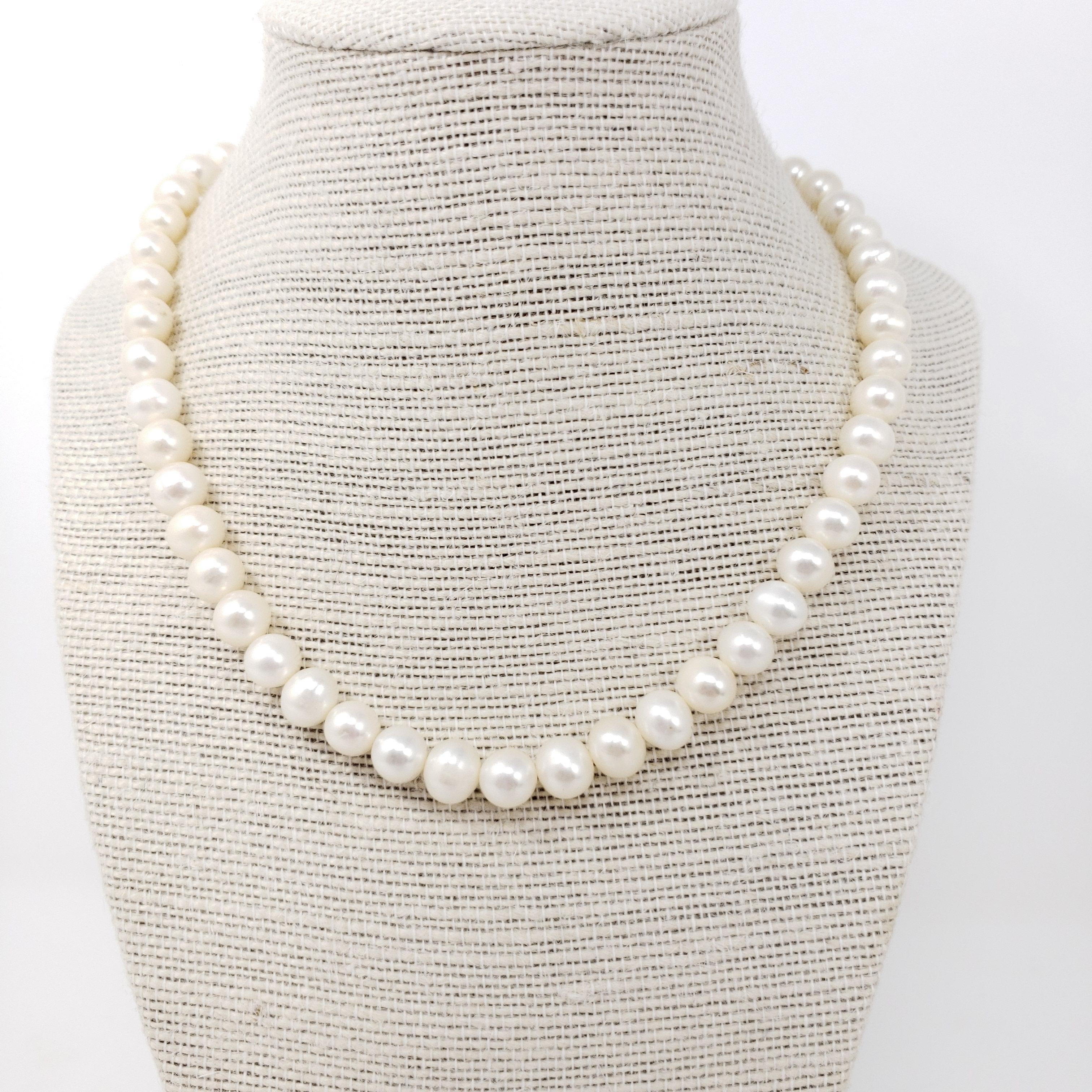 Vintage pearl necklace, featuring a single, 16.5 inch strand of white pearls with a sterling silver clasp. An exquisite accessory!