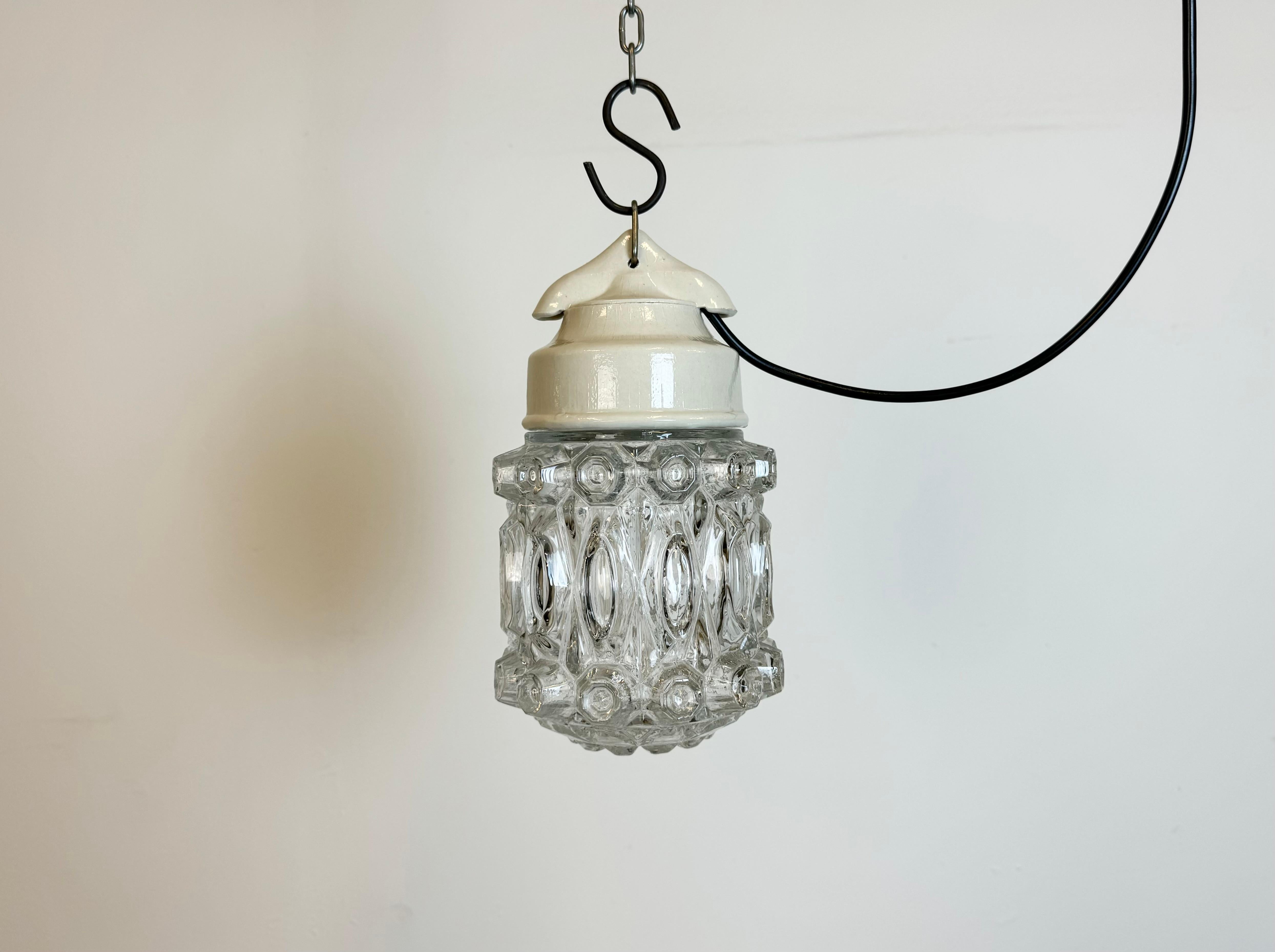 Vintage industrial light made in former Czechoslovakia  during the 1970s. It features a white porcelain top and a glass cover. The socket requires standard E27/ E26 light bulbs. New wire. The weight of the light is 1,4 kg.
Dimensions:
Diameter of