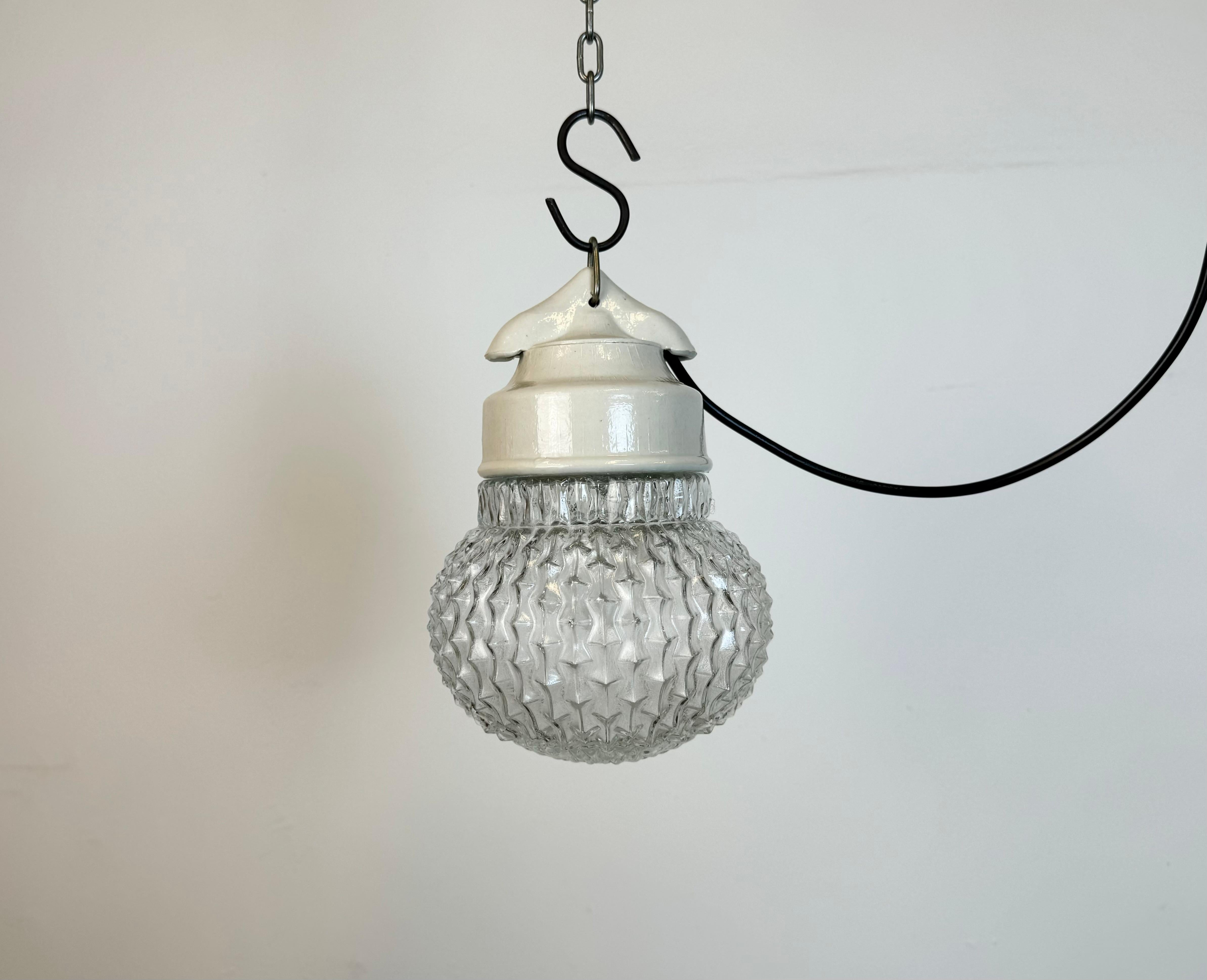 Vintage industrial light made in former Czechoslovakia  during the 1970s. It features a white porcelain top and a glass cover. The socket requires standard E27/ E26 light bulbs. New wire. The weight of the light is 1 kg.
Dimensions:
Diameter of the
