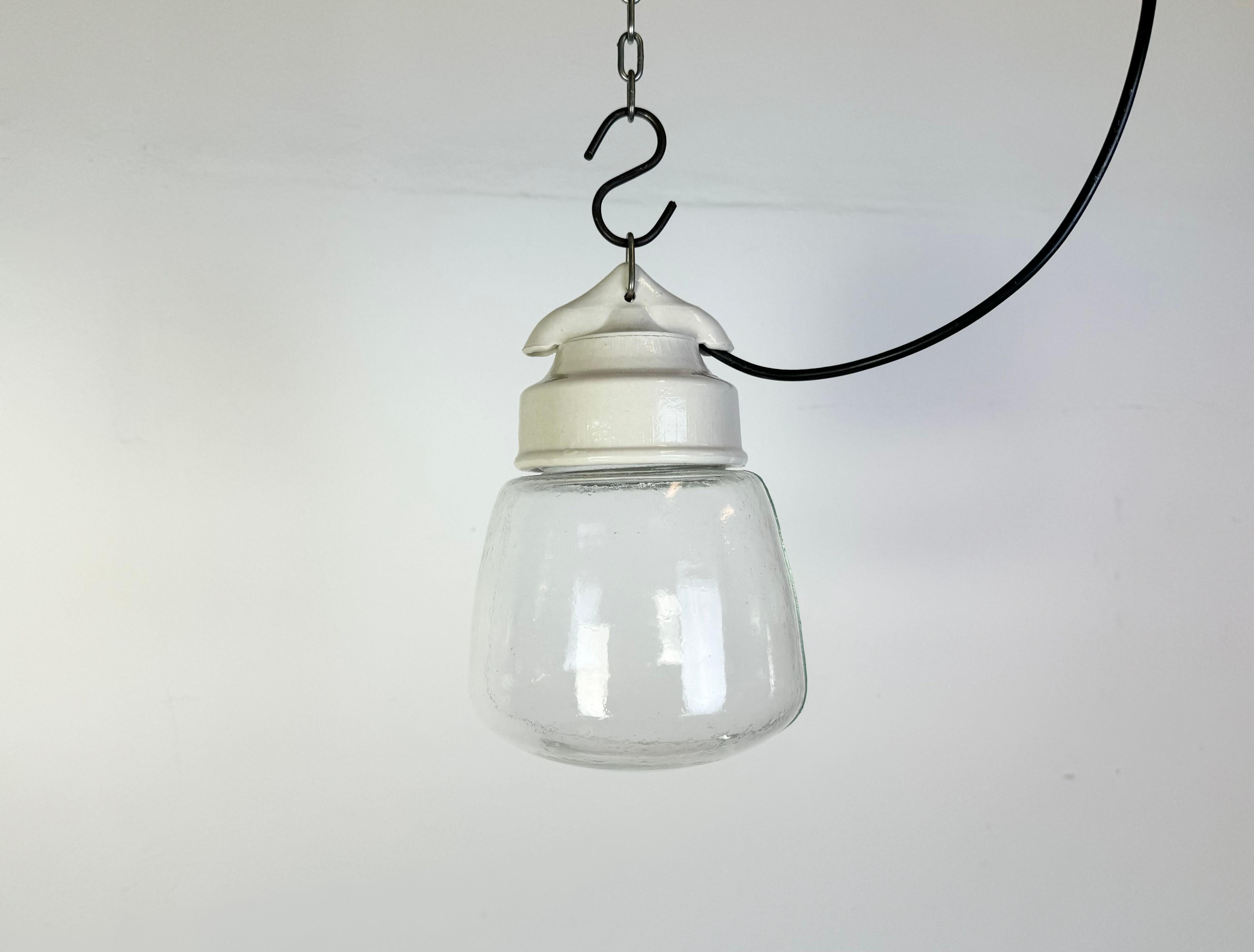 Vintage industrial light made in former Czechoslovakia  during the 1970s. It features a white porcelain top and a glass cover. The socket requires standard E27/ E26 light bulbs. New wire. The weight of the light is 1 kg.
Dimensions:
Diameter of the