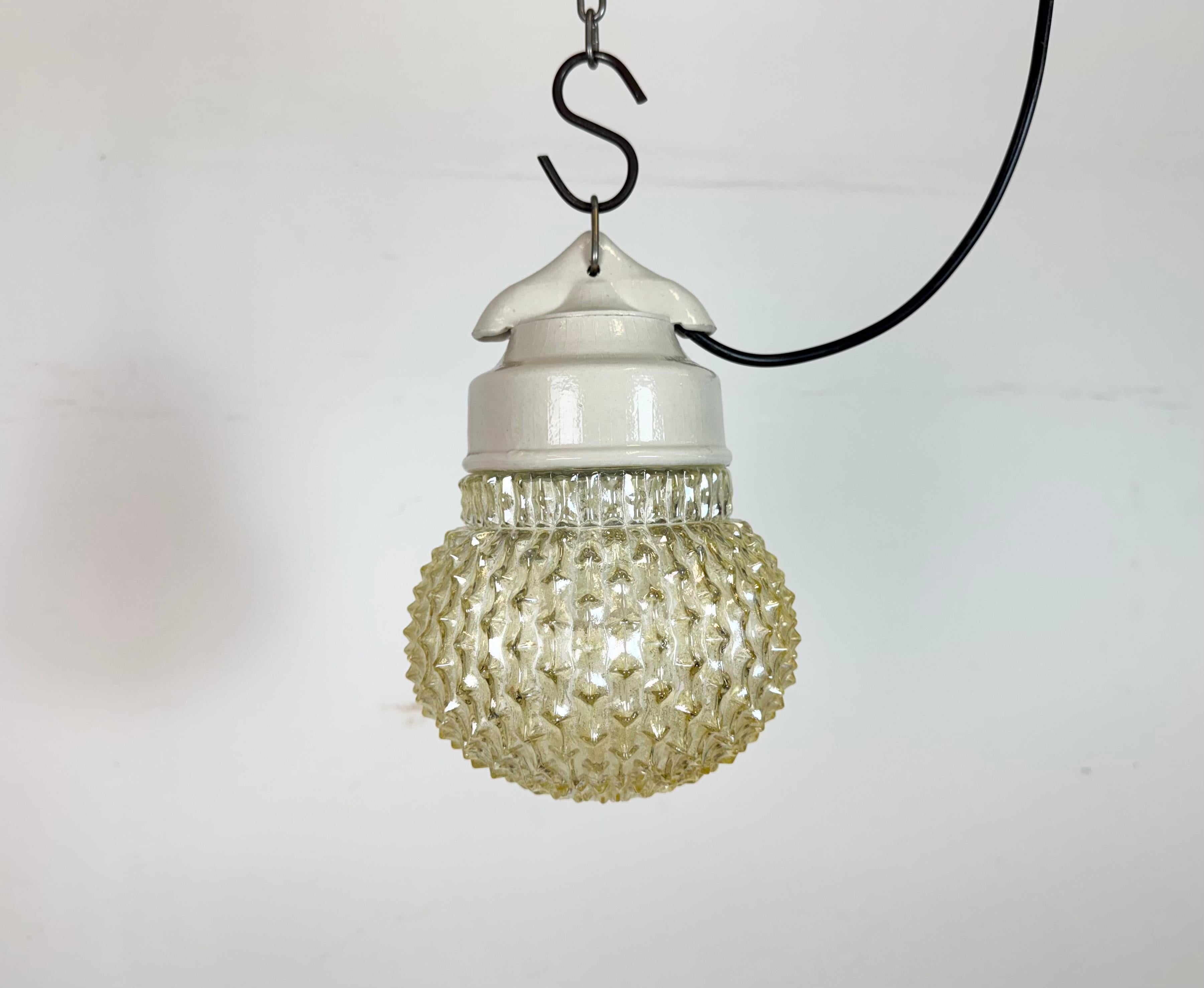 Vintage industrial light made in former Czechoslovakia  during the 1970s. It features a white porcelain top and a glass cover. The socket requires standard E27/ E26 light bulbs. New wire. The weight of the light is 1 kg.
Dimensions:
Diameter of the