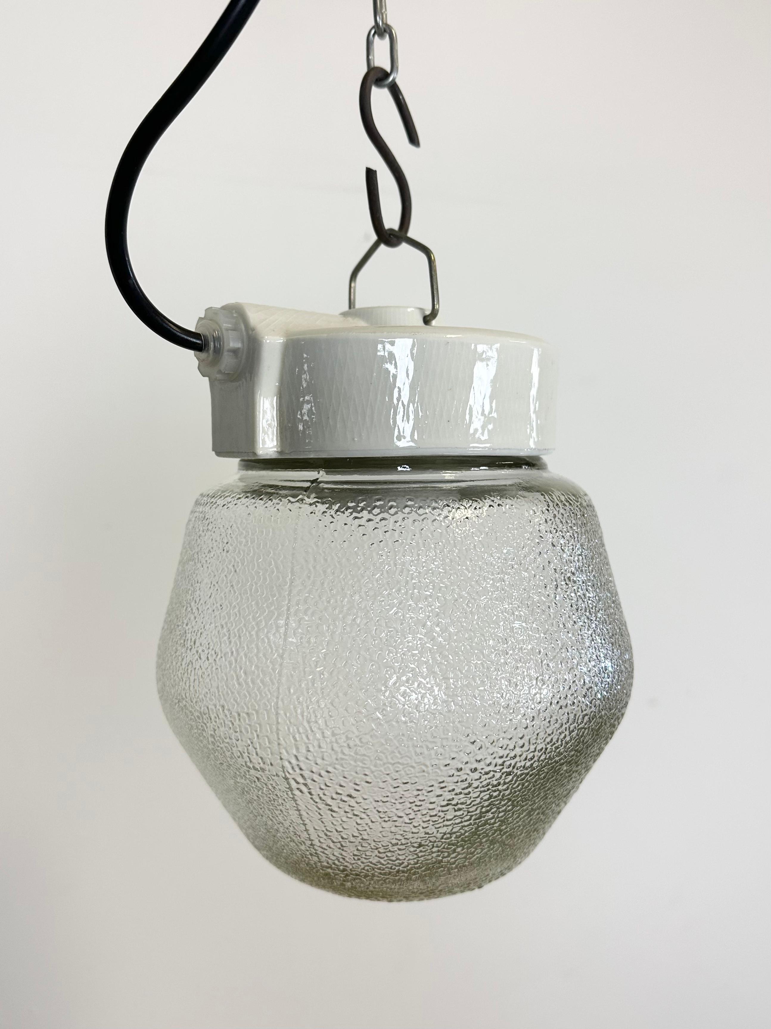 Vintage industrial light made in Poland during the 1970s. It features a white porcelain top and a frosted glass cover. The socket requires E27/ E26 light bulbs. New wire. The weight of the light is 1 kg.
