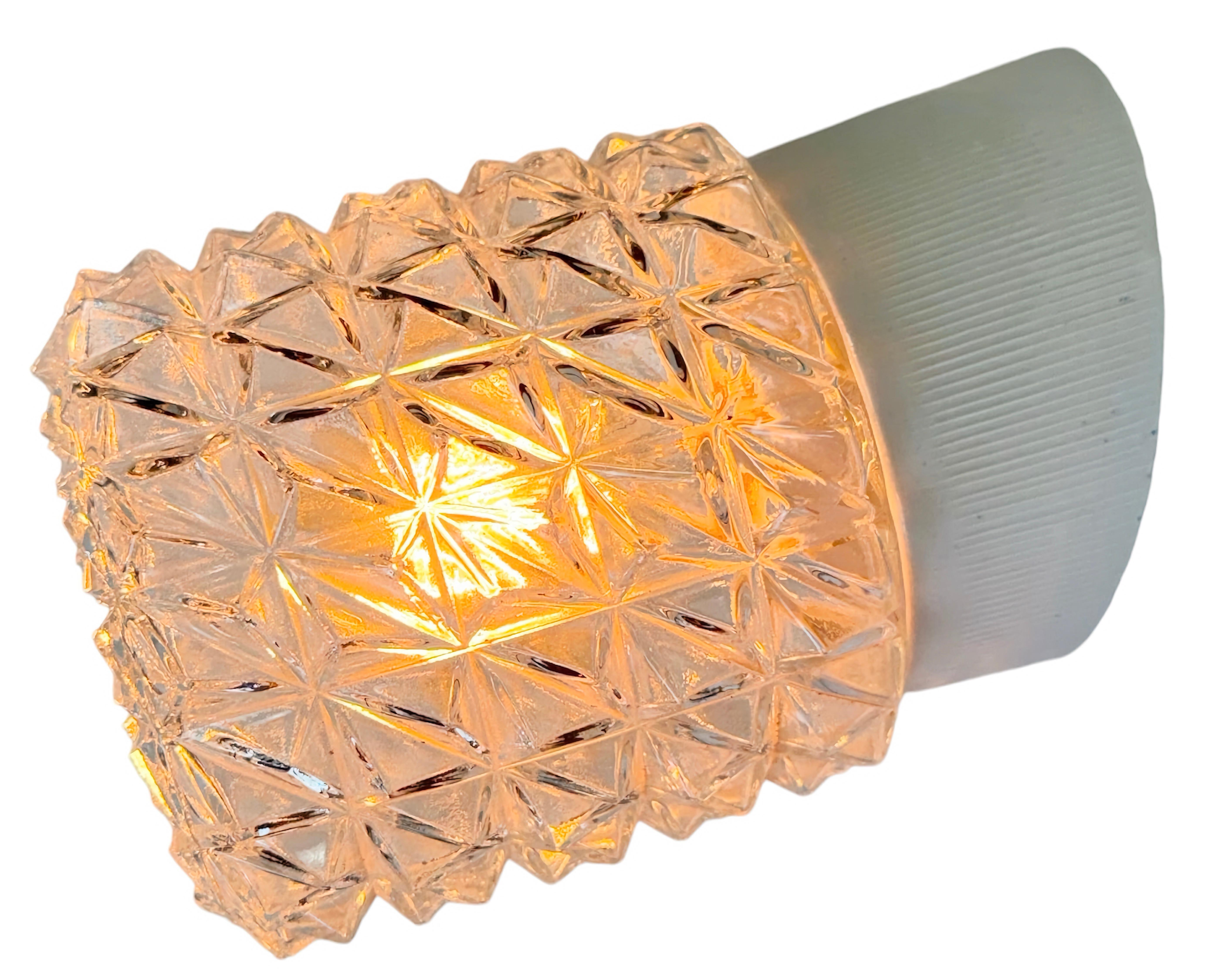 Vintage industrial light made in former Czechoslovakia the 1970s. It features a white porcelain wall mounting and a glass cover. The socket requires standard E27/E 26 light bulbs. New wire. The weight of the lamp is 1 kg.
Dimensions: 
Diameter of