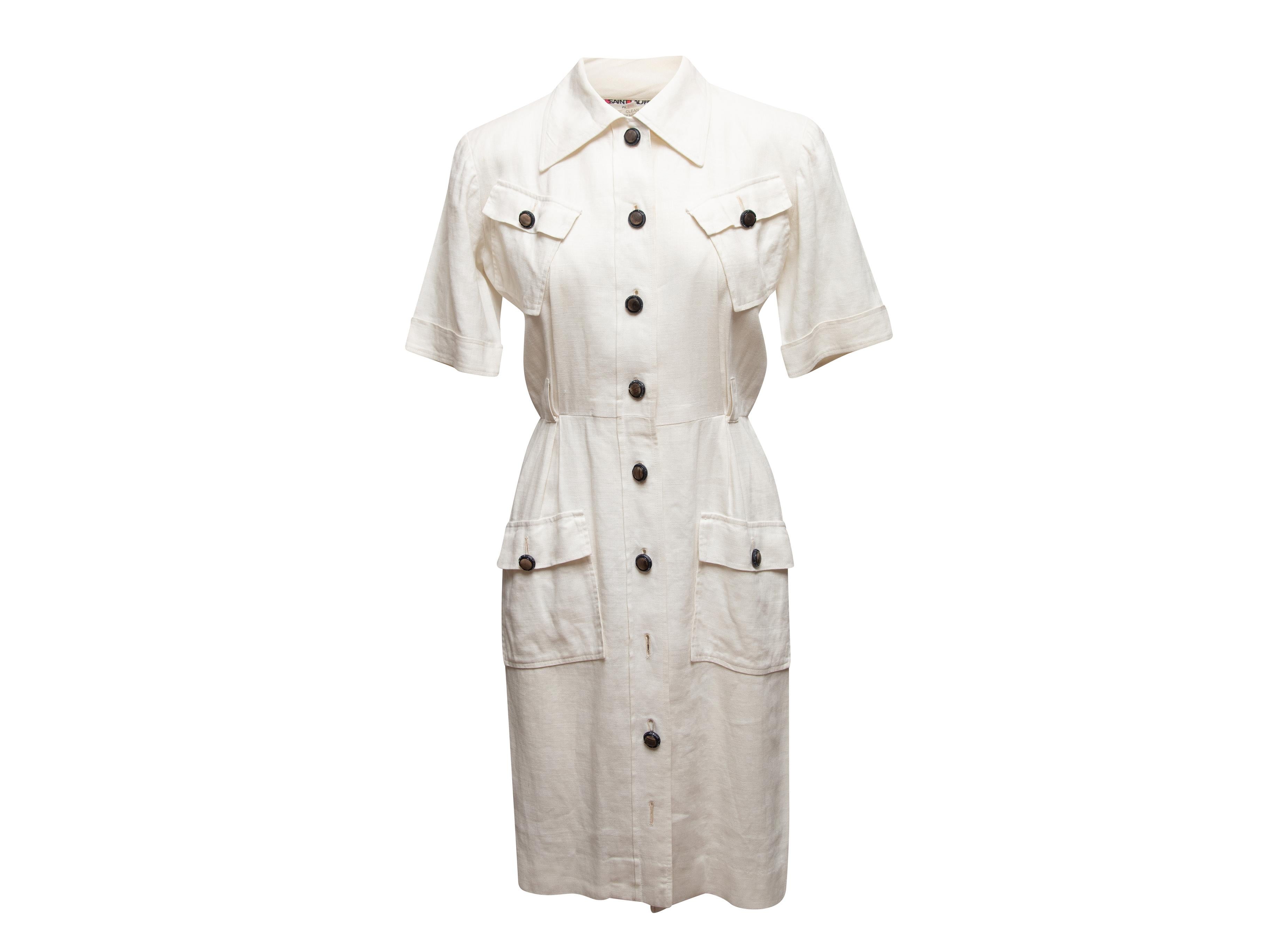 Vintage white linen dress by Saint Laurent. Circa 1970s. Pointed collar. Four flap pockets at front. Button closures at front. Designer size 38. 38