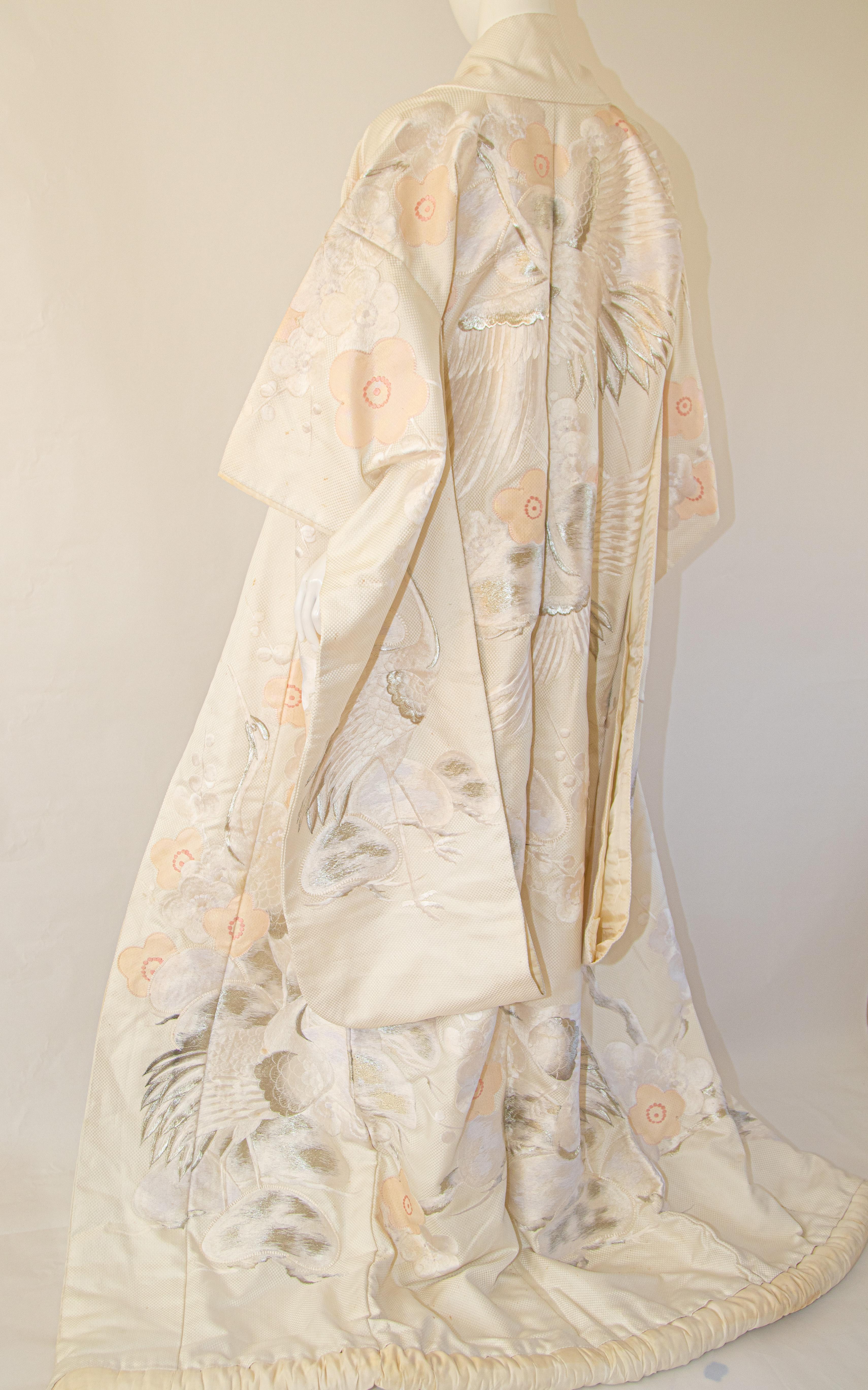 A vintage midcentury ivory white silk brocade collectable Japanese ceremonial wedding kimono.
One of a kind handcrafted fabulous museum quality ceremonial piece in pure silk with intricate detailed hand-embroidery throughout accented with silver