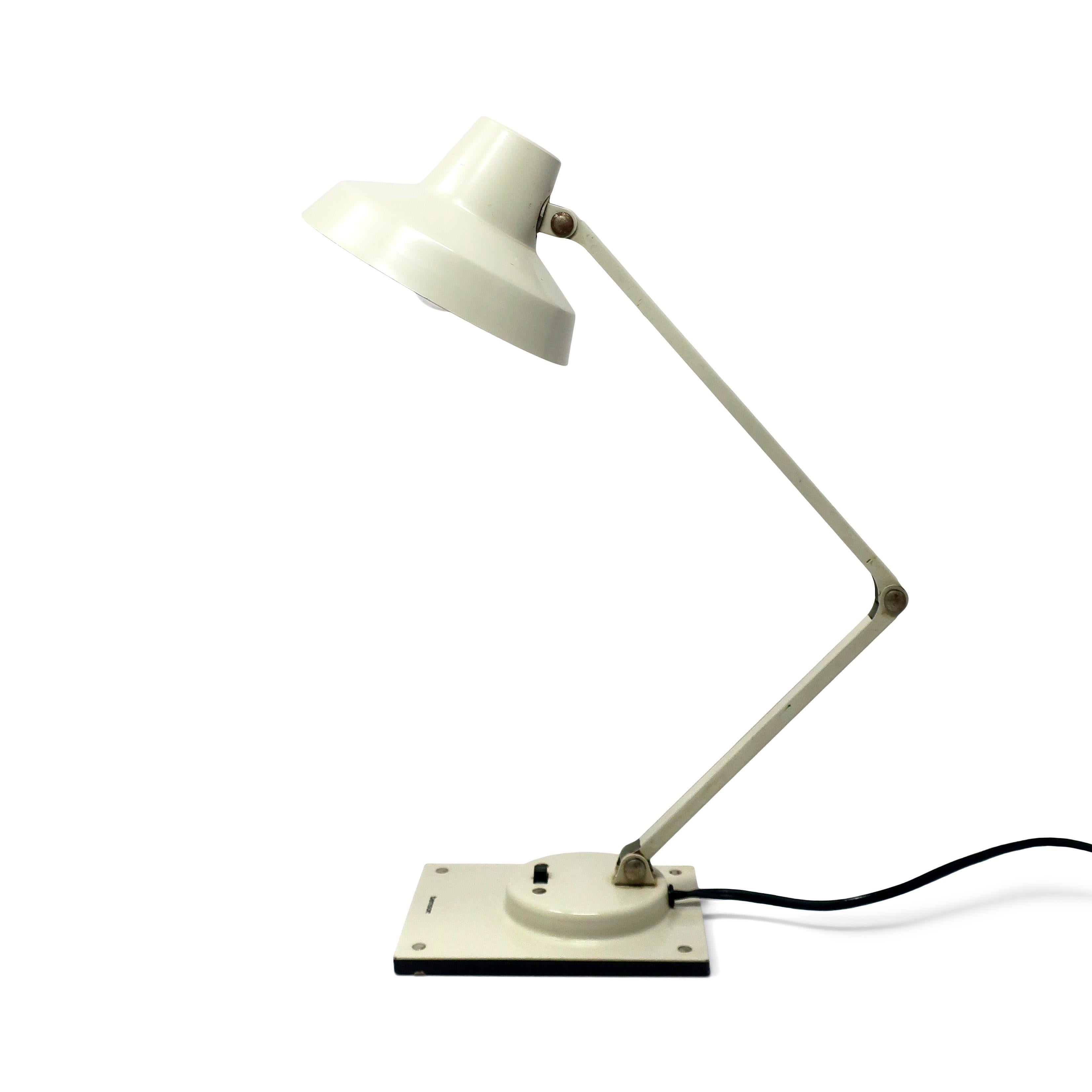 A perfect mid-century modern Tensor IL 400 articulating desk lamp.  White textured base and shade, white stem, and switch on the base.  In good vintage condition.

4
