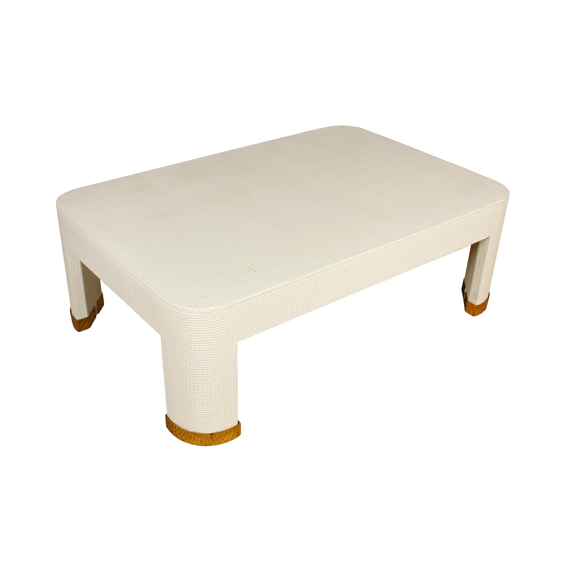 Vintage white textured cocktail table with brass feet. Rectangular table with rounded corners and legs.