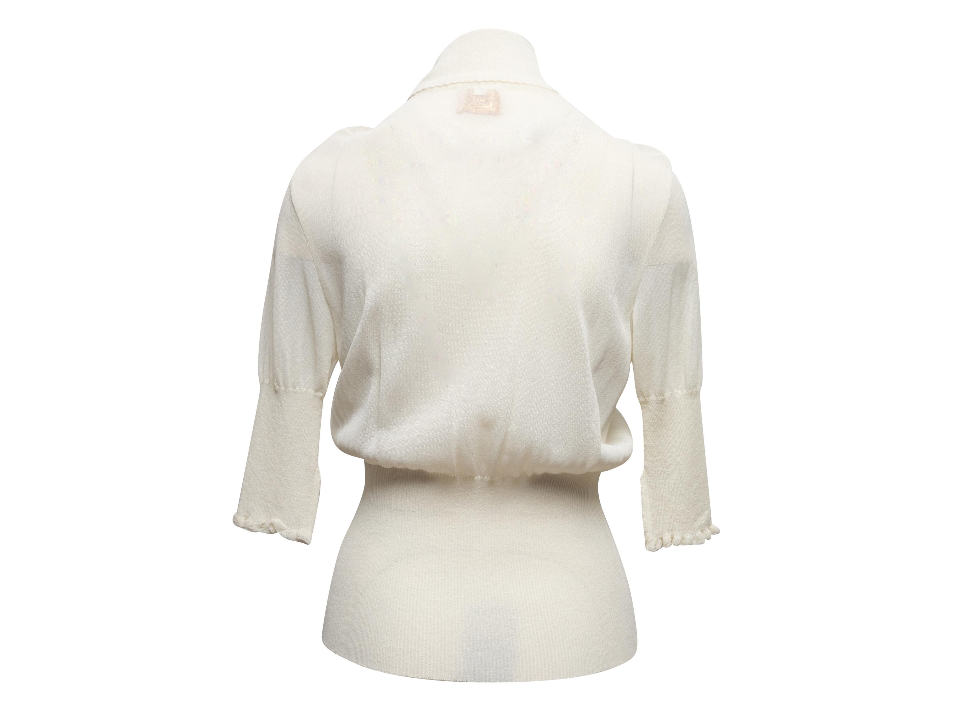 Vintage white ruffle-trimmed knit top by Vivienne Westwood. Short sleeves. Button closures at bust. V-neck. 28
