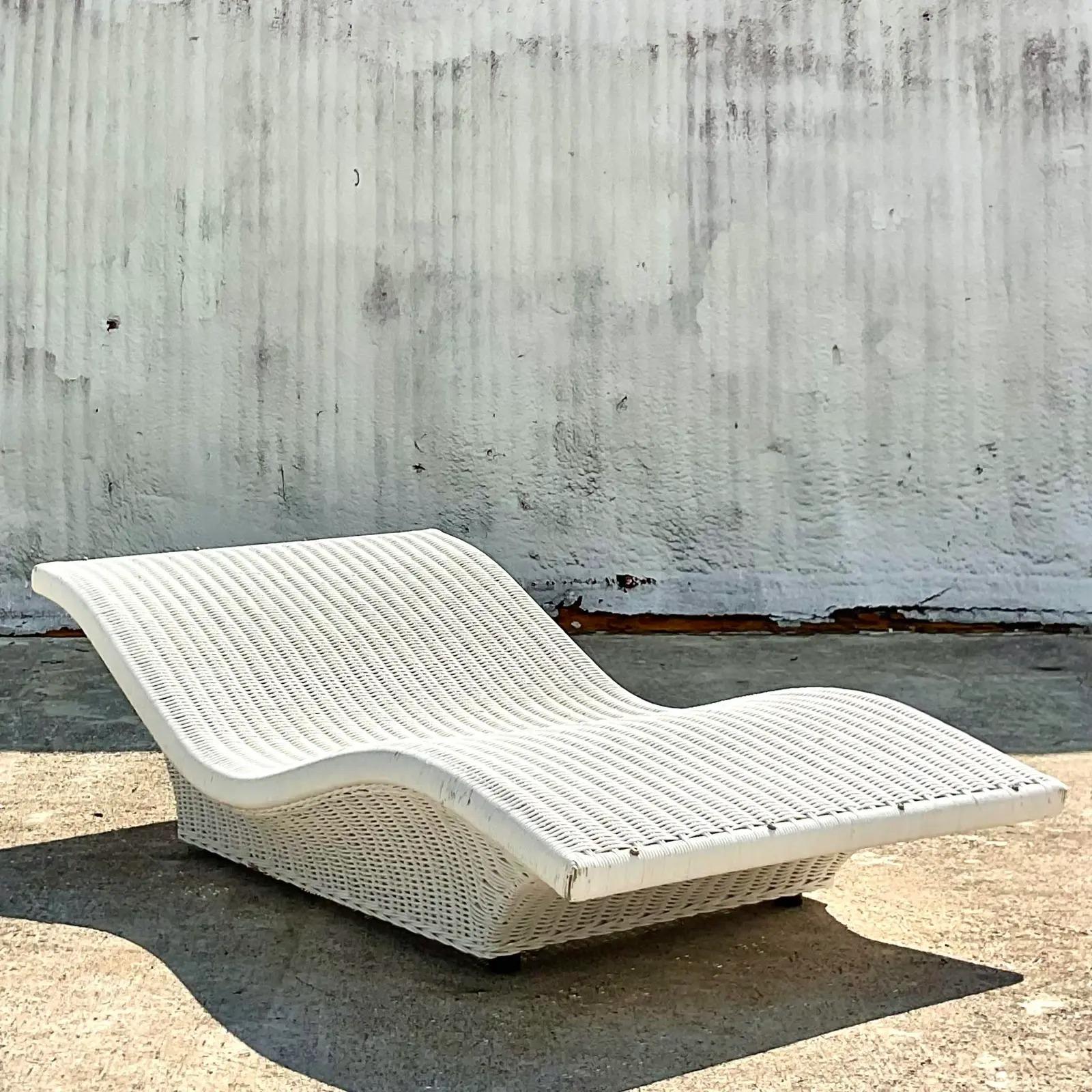 Fantastic vintage Coastal chaise lounge. A fantastic wave design in a white woven rattan. Big and roomy. Acquired from a Palm Beach estate.