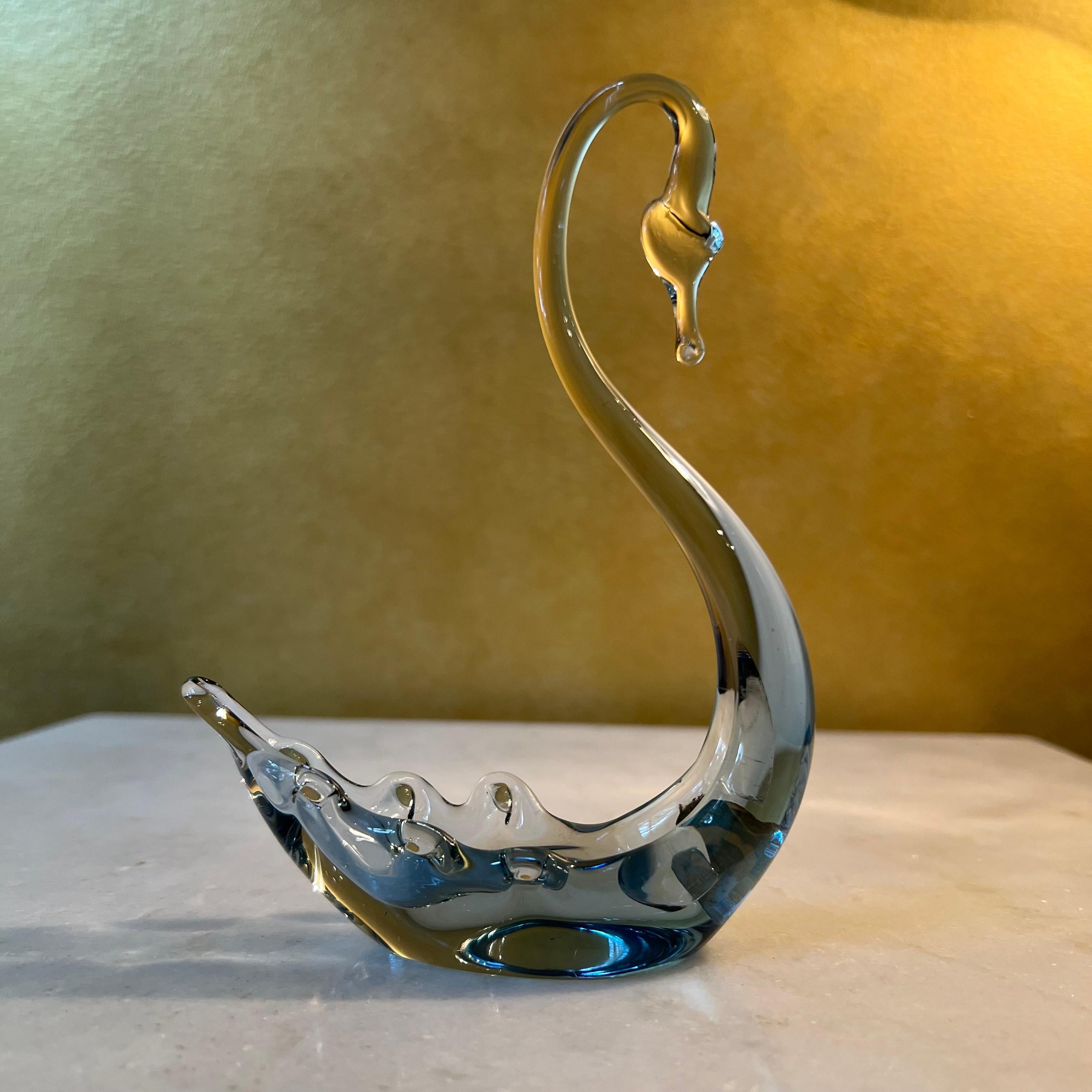Smoke grey and clear glass swan, sticker Whitefriars, England 

Circa: 1960s

Material: Glass

Country Of Origin: England 

Measurements: 15cm high, 11.5cm length, 3.5cm width

Postage via Australia Post with tracking available