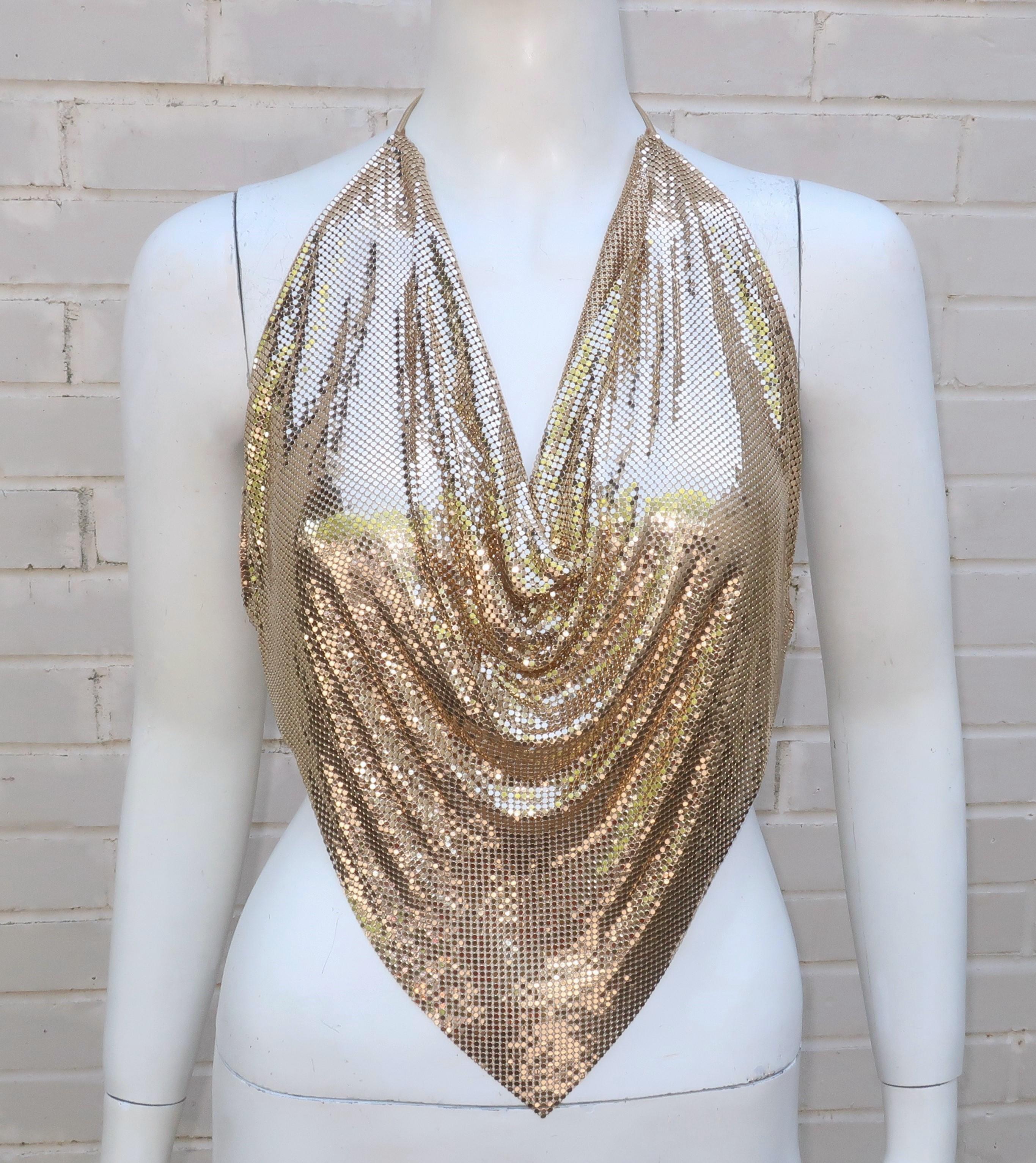 Get the midas touch with a vintage Whiting & Davis gold chain mail mesh halter top with gold leather ties.   The mesh 'fabric' is Whiting & Davis' signature material which hearkens back to the early 1900's.  The top has felt lined edges to keep it