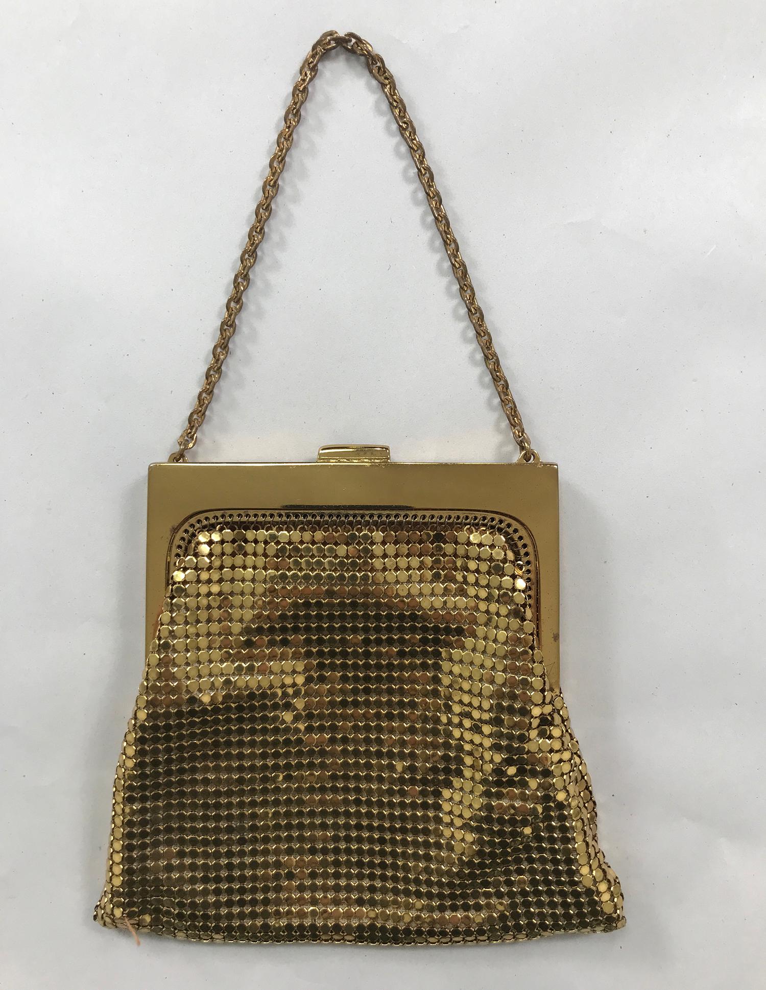 Vintage Whiting & Davis gold metal mesh wrist-let, evening bag from the 1960s. Gold metal frame with tab front and snap closure. With a gold chain handle. The bag is lined in off white taffeta. Looks unused. The perfect size to wear on your wrist