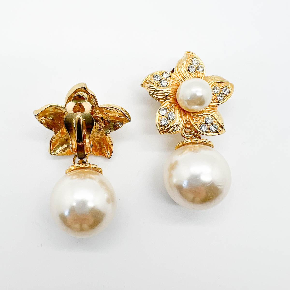 A pair of Vintage Pearl Flower Earrings. A delightful flower motif set with crystals proves high drama with the whole pearl centre and huge whole pearl drops. Utterly spellbinding earrings. 
An unsigned beauty. A rare treasure. Just because a jewel