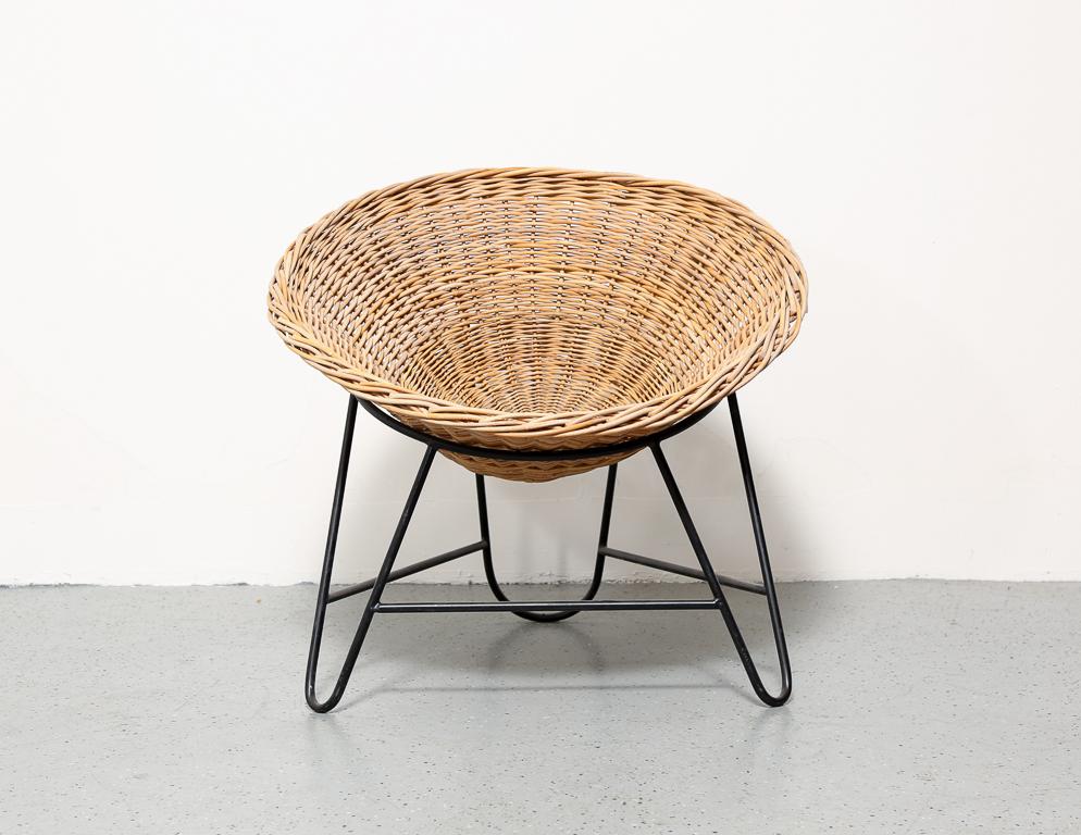 Vintage wicker basket chair sitting in an angular wrought iron frame. From the Netherlands.