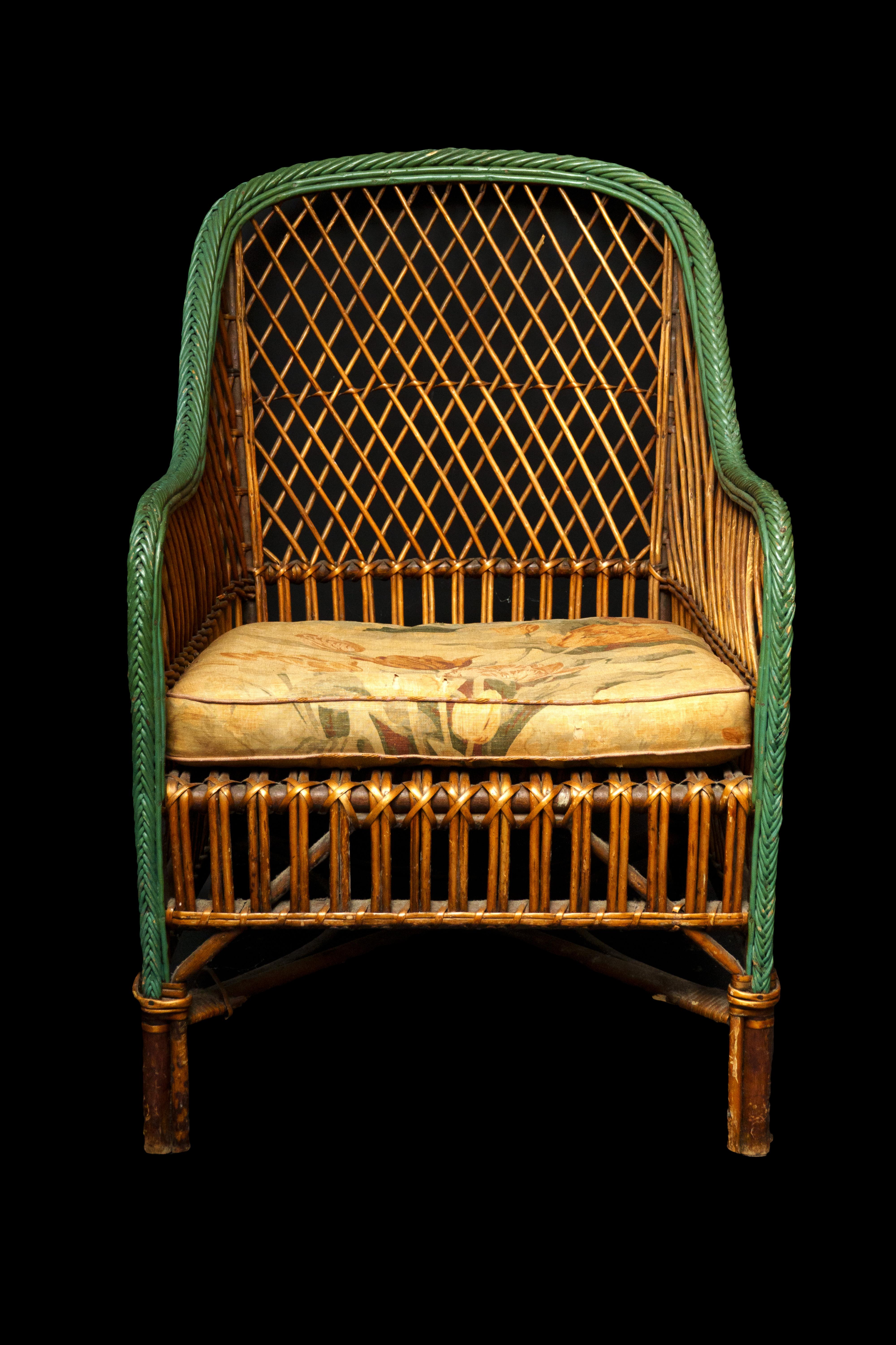 Vintage wicker chair w/ cushion and a green painted edge.

Measures: 24