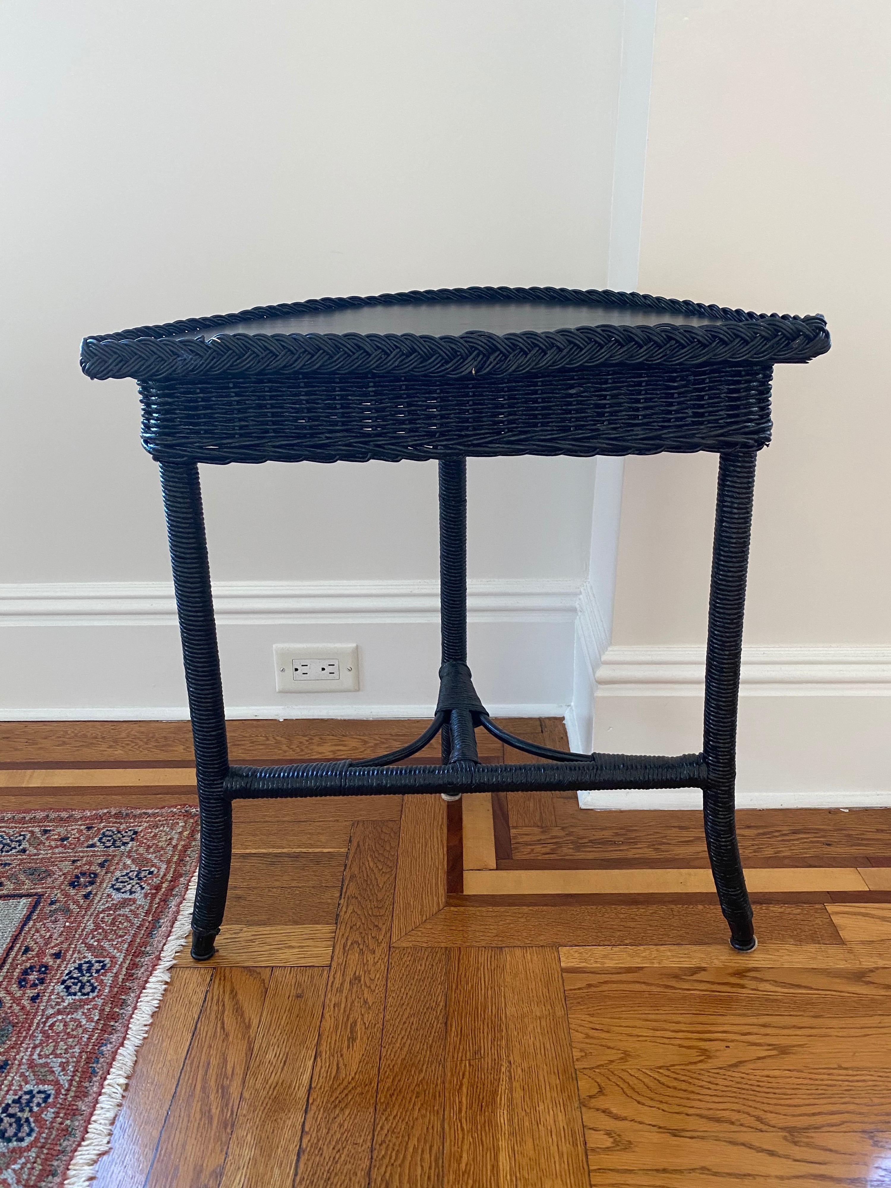 Vintage wicker demilune in black finish
Classic wicker in a fresh sharp finish. Small size is perfect for a small space or entry.
Measures: 24 1/4 H (including 1/8-1/2” braided lip) x 10.5” deep x 21” wide
8.5” floor clearance.