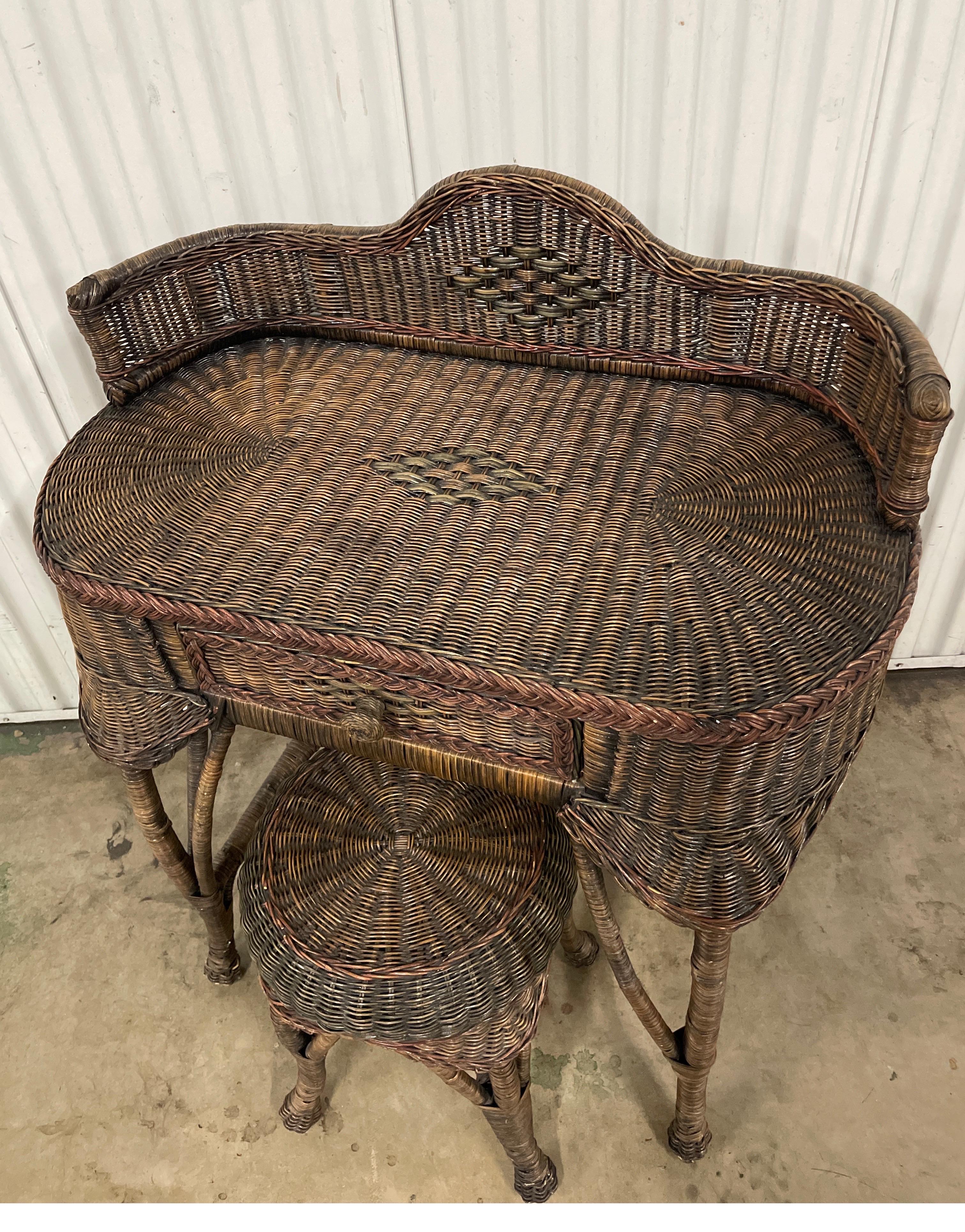 Vintage wicker dressing table / writing table with stool. It is oval shaped with a raised galleried back. There is one center drawer.  This very versatile piece can be used as a dressing table or small desk. The height to top of writing surface is
