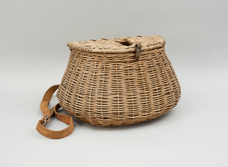 Vintage Wicker creel.
A very good example of an early wicker pot bellied fishing creel. The creel is made in the traditional design with a hinged lid with leather buckle and a leather shoulder strap.

The creel was an important piece of equipment