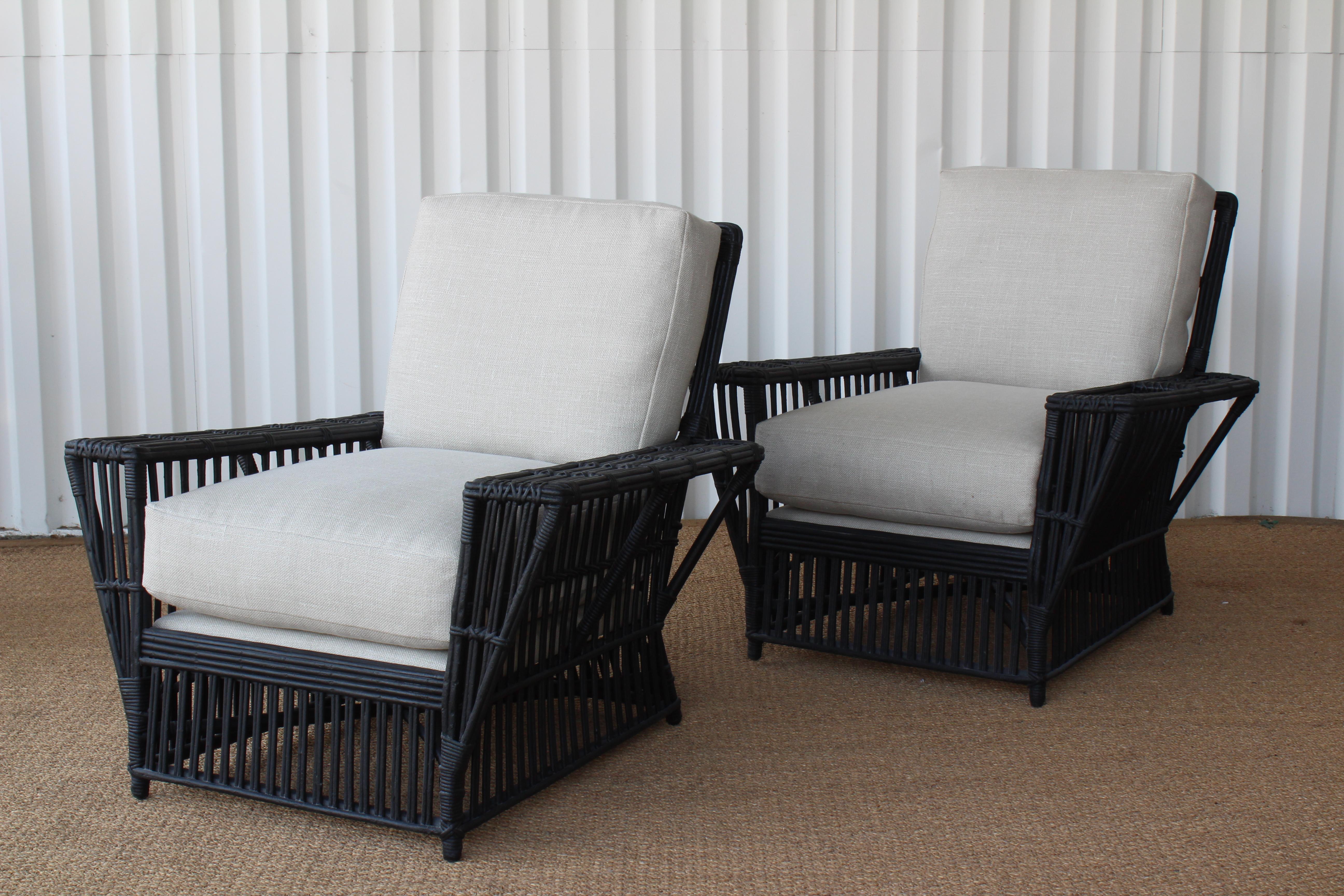 Pair of vintage wicker lounge chairs, France, 1930s. Newly repainted in a flat black. Newly reupholstered in a neautral woven fabric.