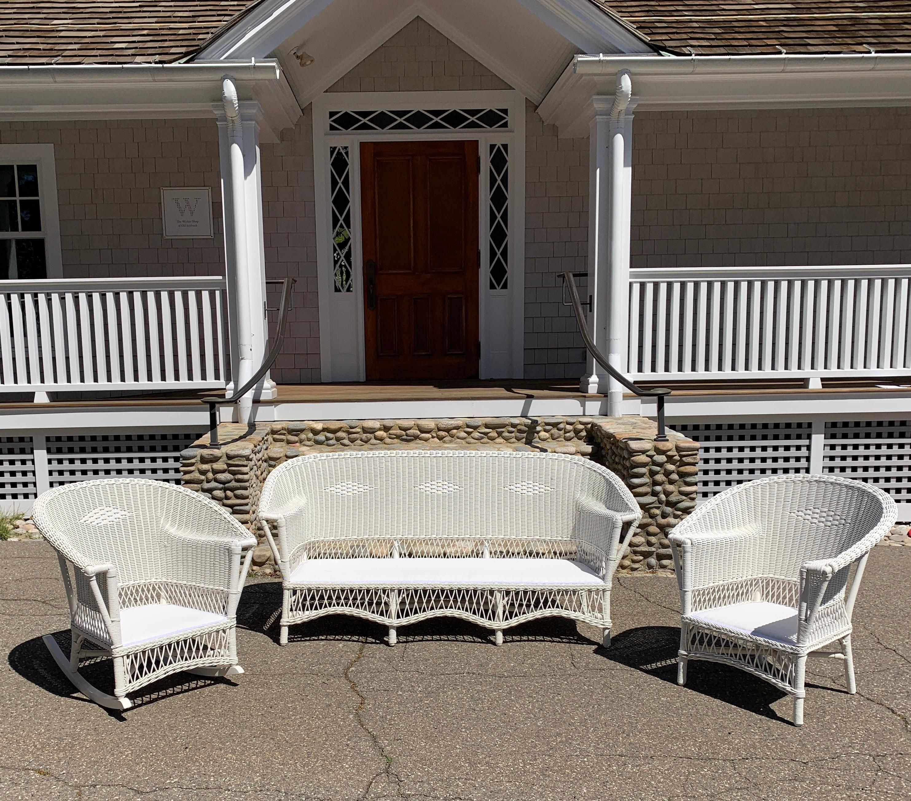 This is a classic three piece wicker set from the 1920’s freshly painted white and with new Sunbrella decking. The sofa measures 71” wide, 28” deep and 33” tall. The chair measures 31” wide, 27” deep, 34” tall. The rocker measures 31” wide, 34