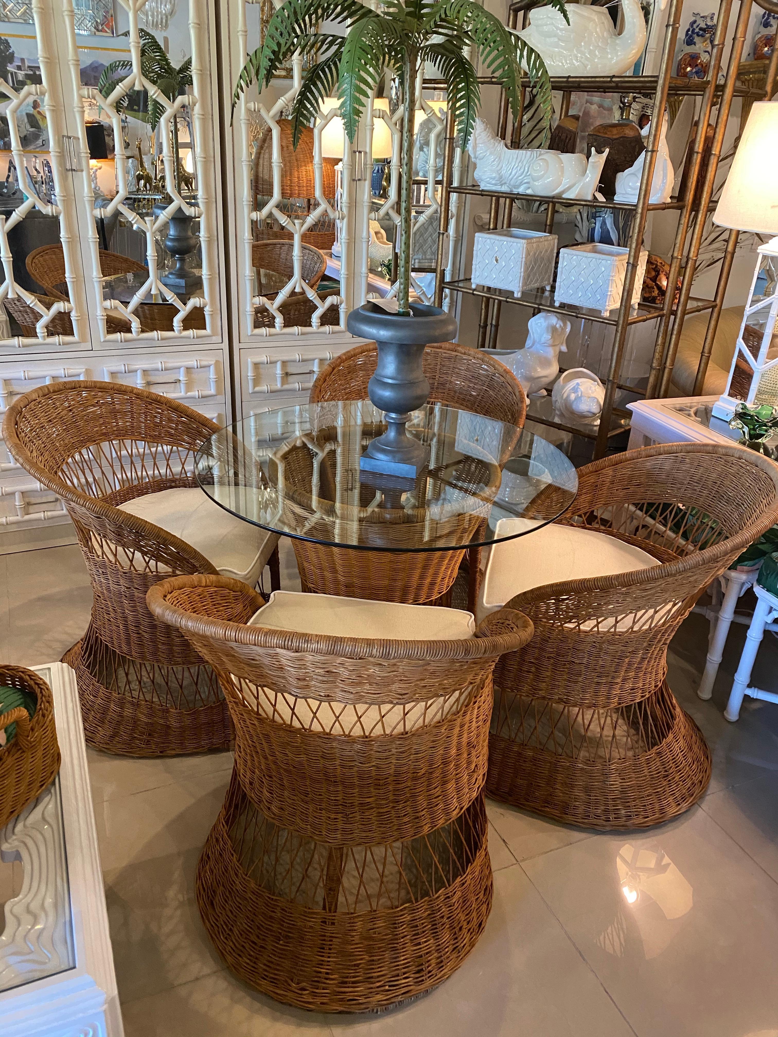 Vintage 5-piece wicker and rattan dining table set. Set includes 4 dining chairs and dining table base. I am happy to include the glass top but it may have some scratches. Glass pictured is 36