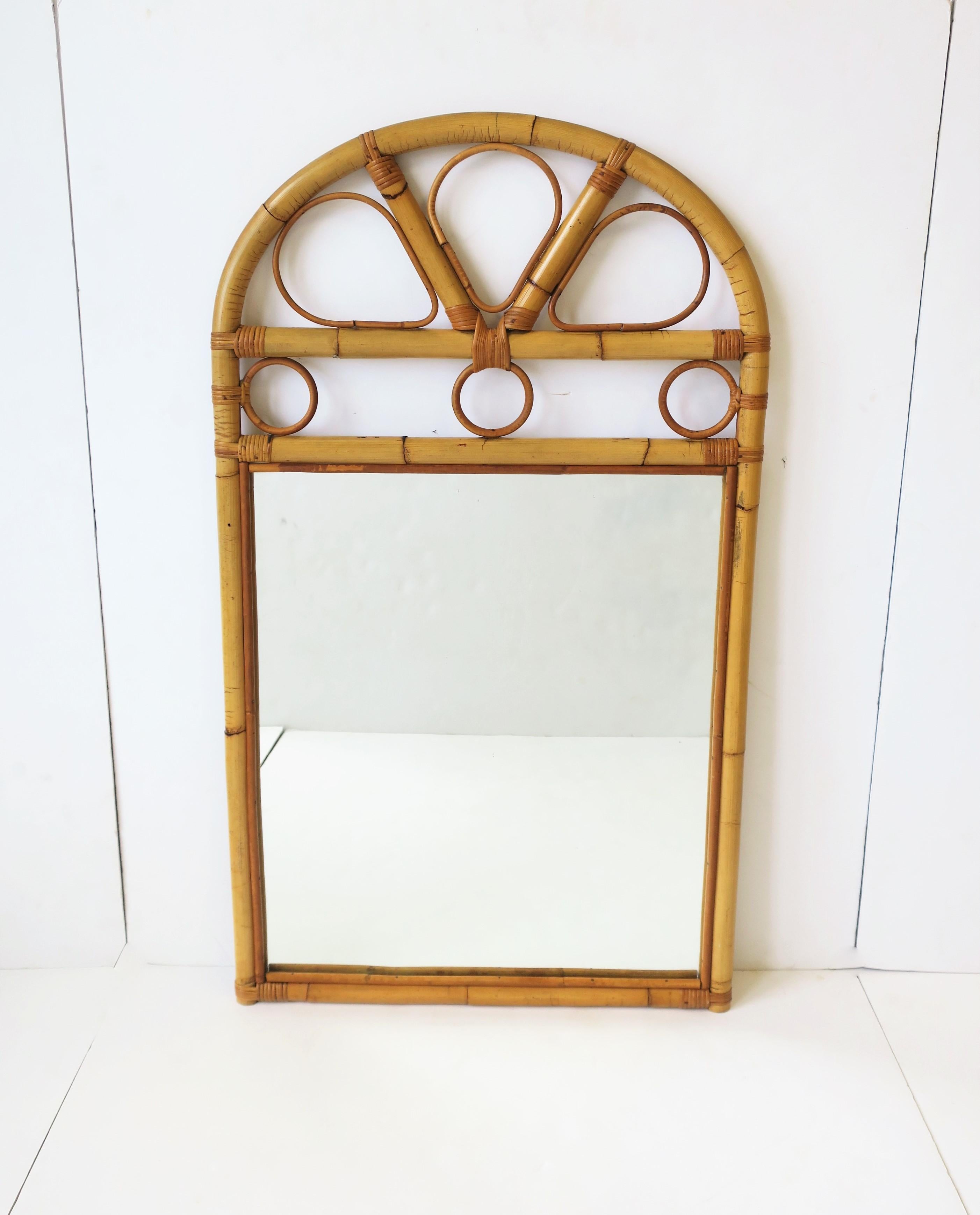 A vintage dark blonde and tan wicker rattan bentwood rectangular wall mirror with loop and circle design, circa 1960s-1970s, USA. If you're looking for bamboo, rattan is an alternative. Dimensions: 21