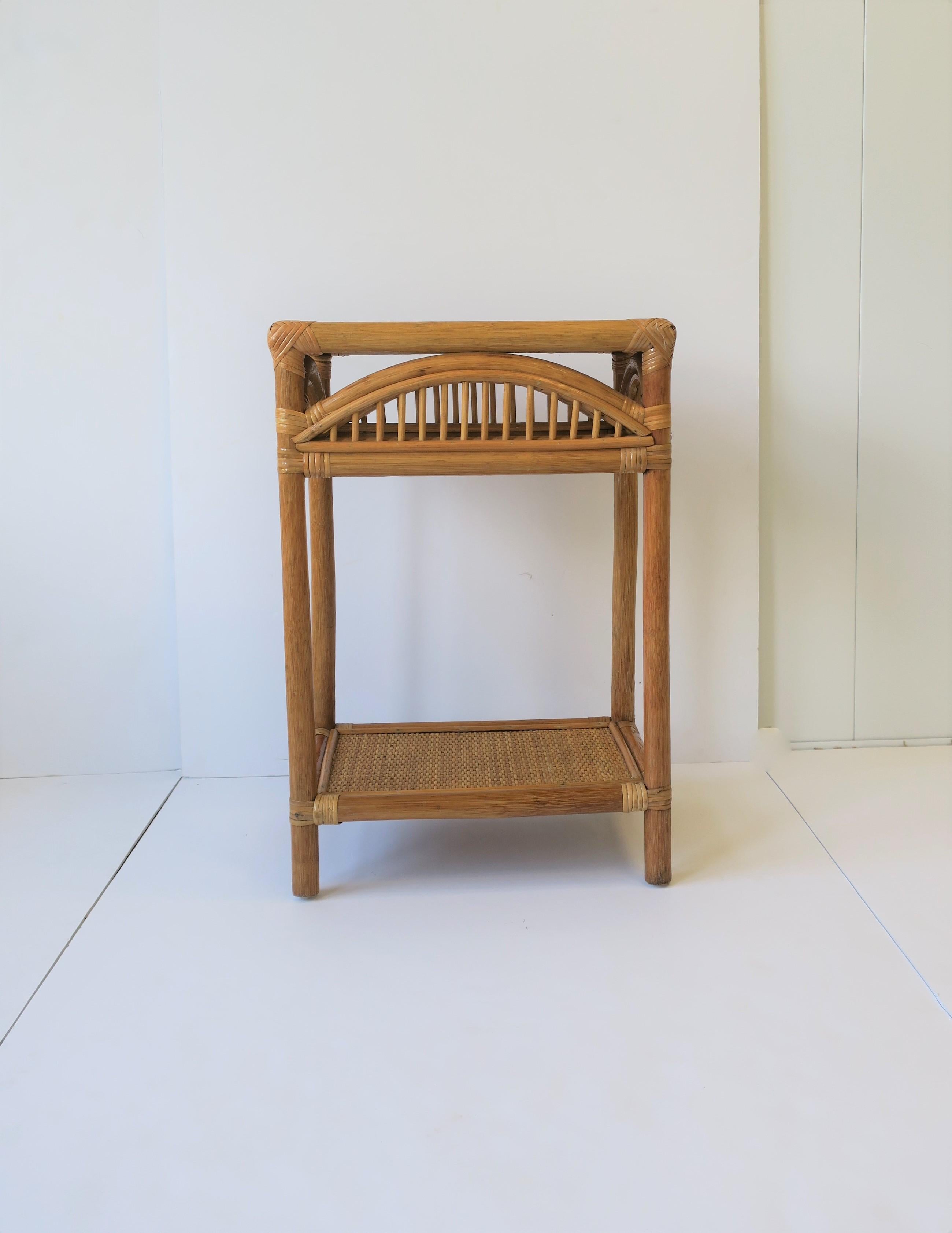 A convenient and relatively small vintage wicker rattan end or side table with lower shelf, circa late 20th century. Table positions demonstrated in images. Table could also be convenient for a bathroom/vanity area. 

Table measurements: 11