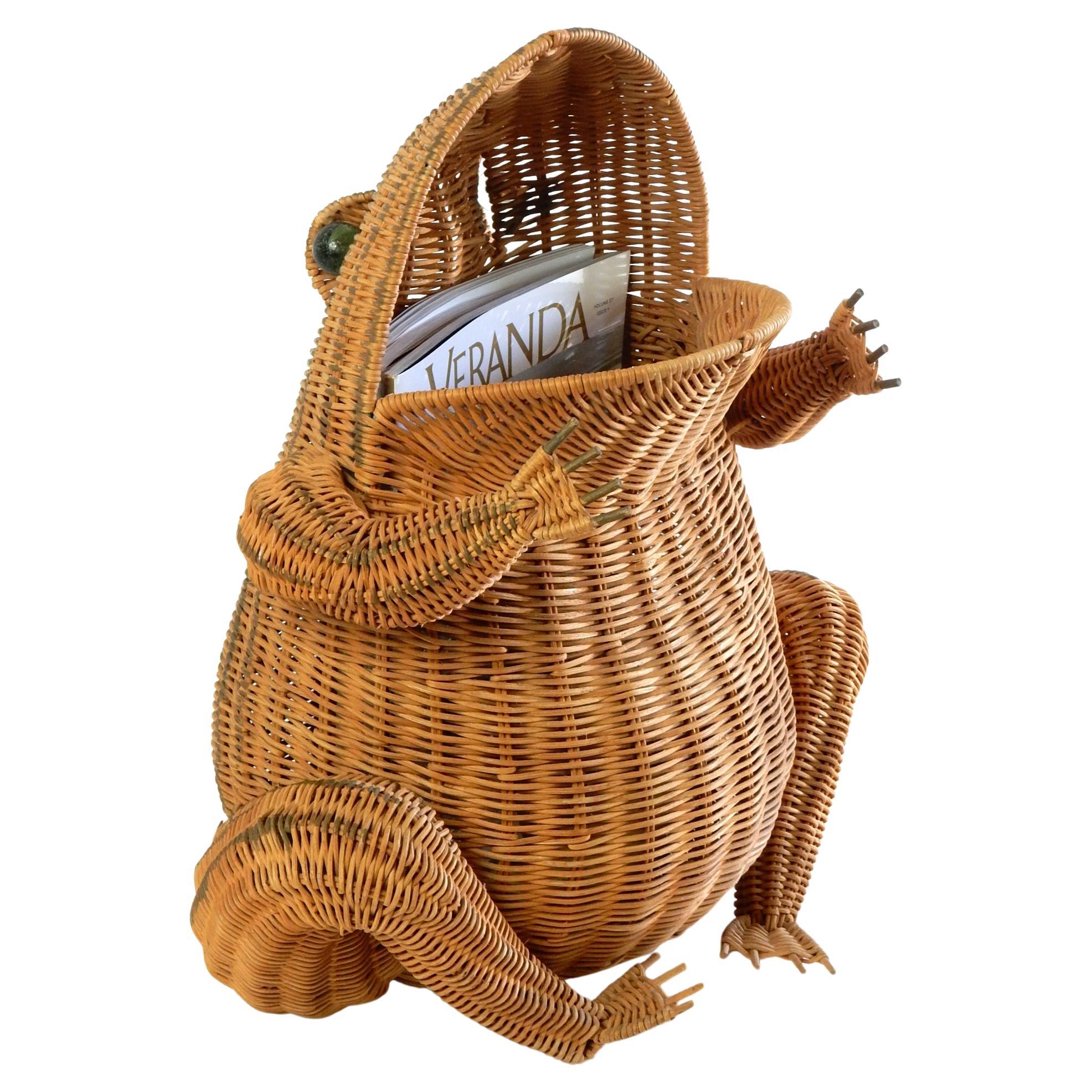 Vintage wicker frog basket which makes a perfect magazine holder or catch-all.
circa 1970s. Glass marble eyes. Green stripes down back. 
Small label on bottom 
