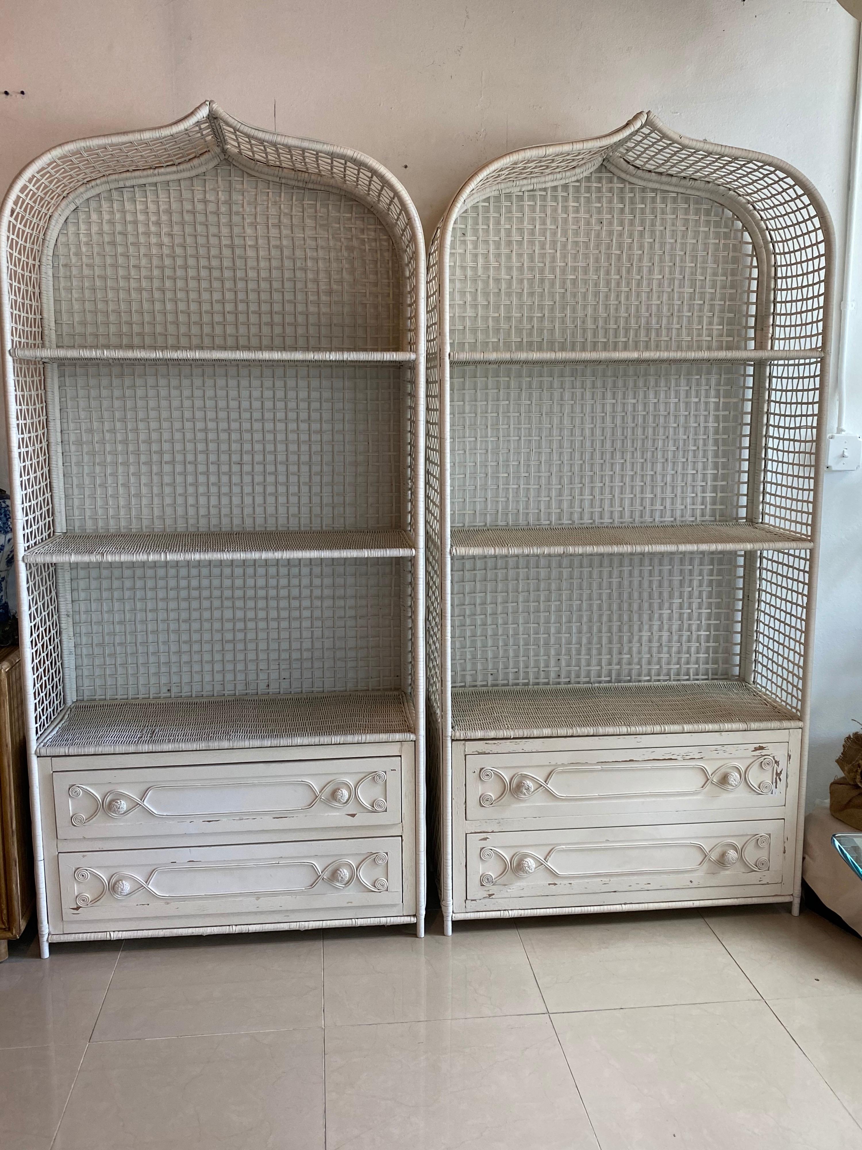 The most amazing pair of vintage wicker and rattan pagoda Moroccan top etagere shelves with two drawers. The details are incredible! The drawer fronts have scrolly wicker designs and wicker knobs. Ive left these there original chippy creamy white