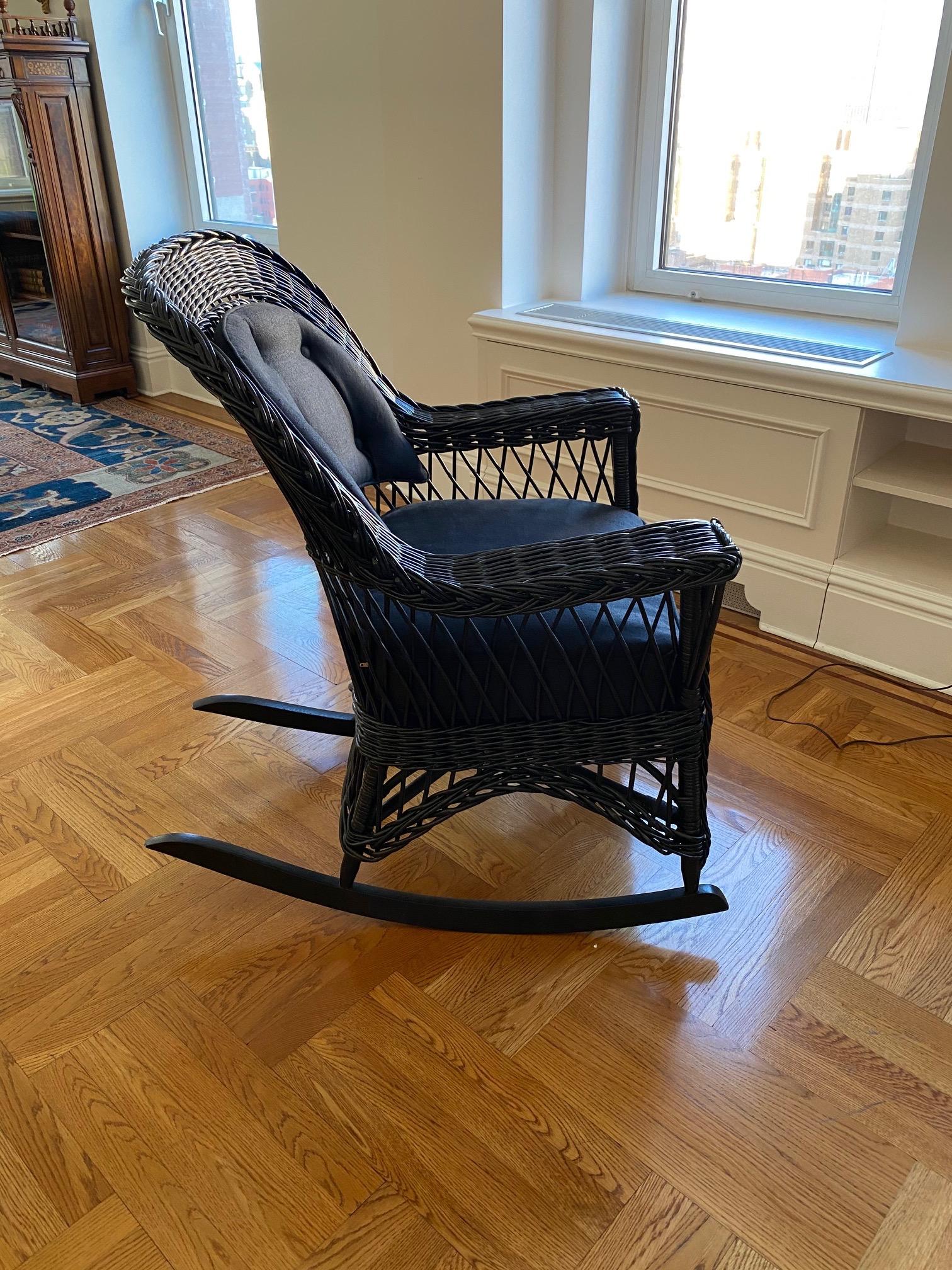 Vintage wicker rocking chair in black finish, upholstered in black linen.
This is a Classic vintage wicker piece was updated with a sharp black finish and upholstered seat and back cushions in black linen. Please note this is part of a larger