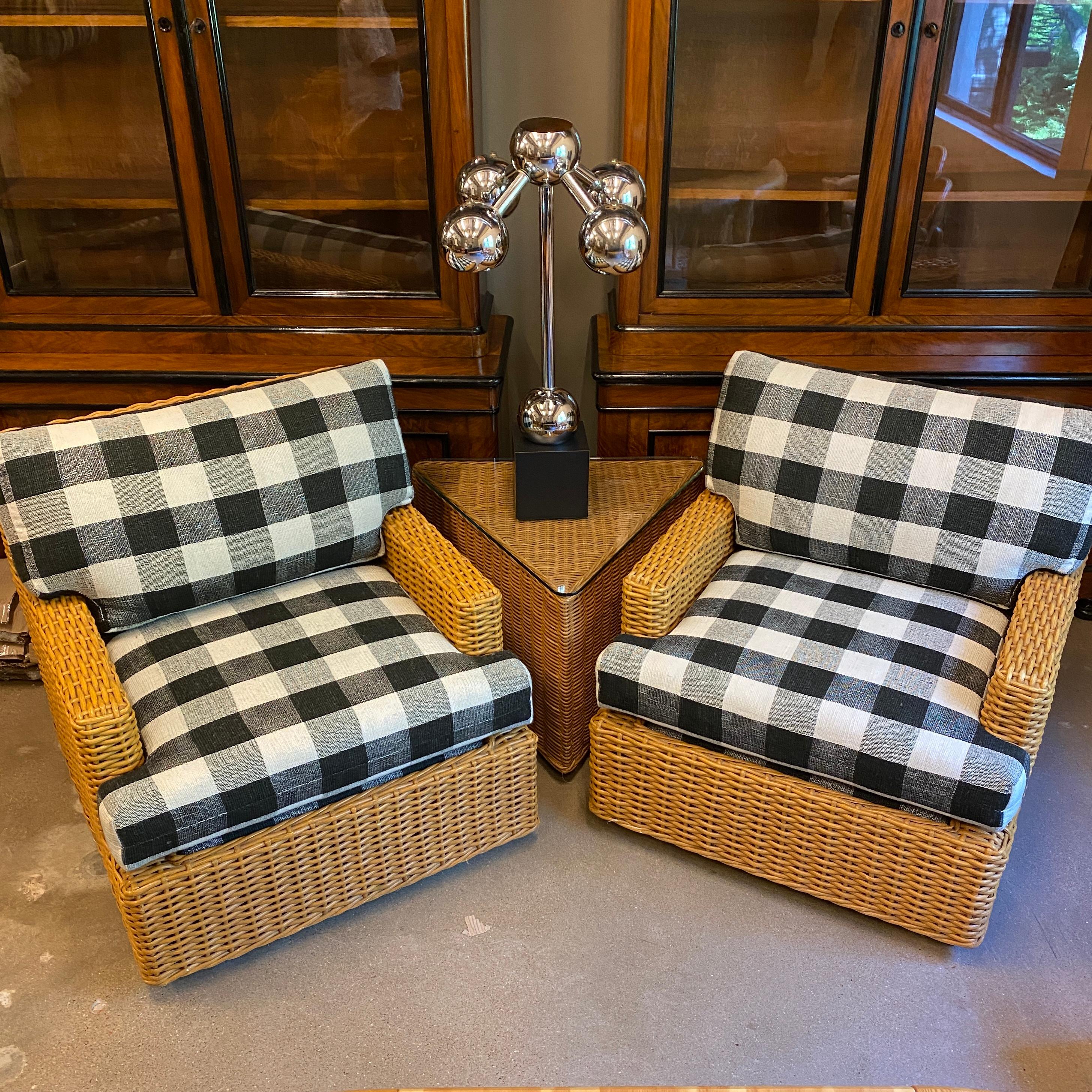 Vintage wicker side tables in triangular shape with glass tops. Two available, sold separately. One piece of glass has chip.

Wicker lounge chairs in image also available at LU1140219356051.