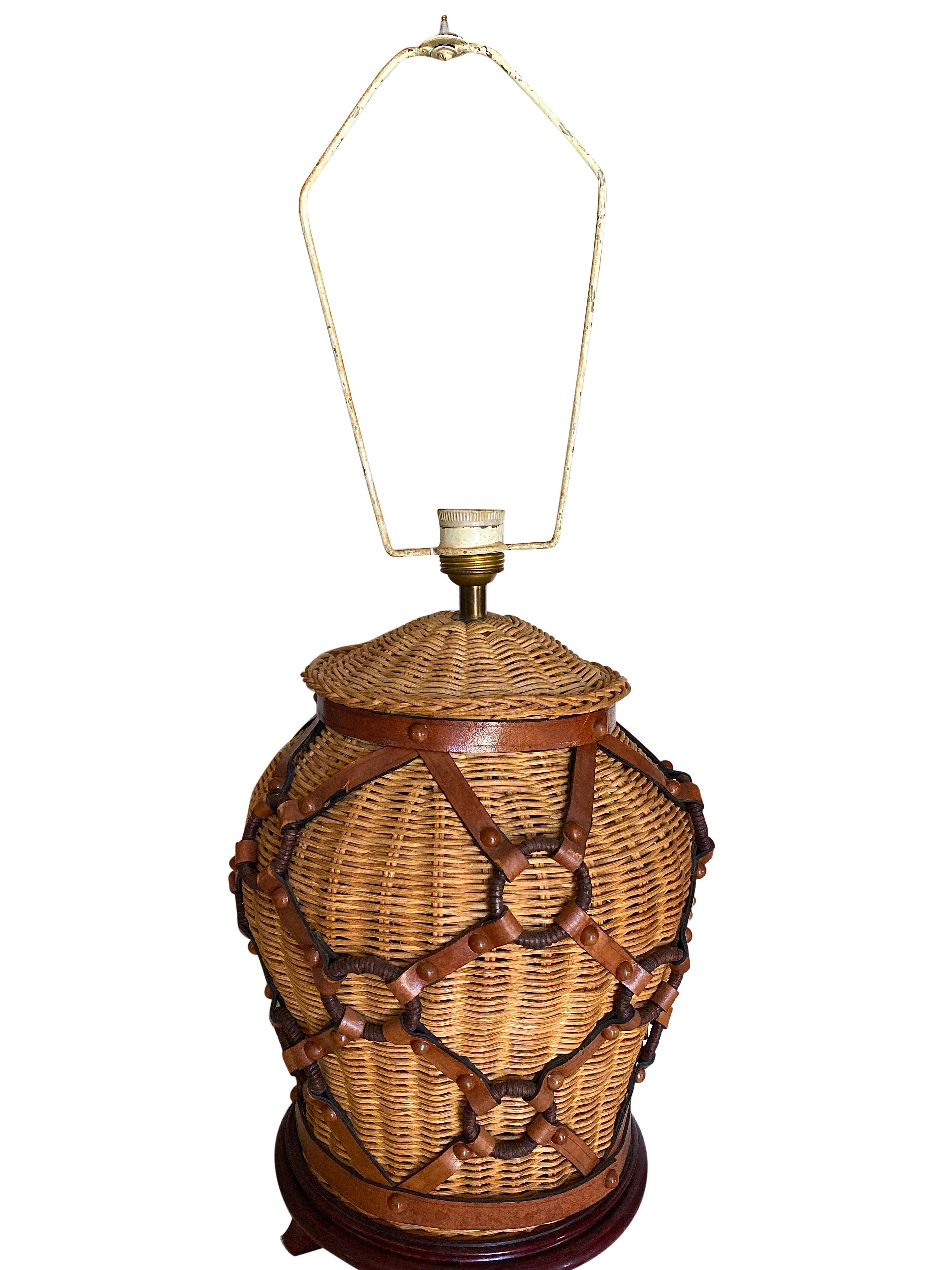 Vintage wicker table lamp with leather strapping and matching wicker lamp shade.

Measures: 25