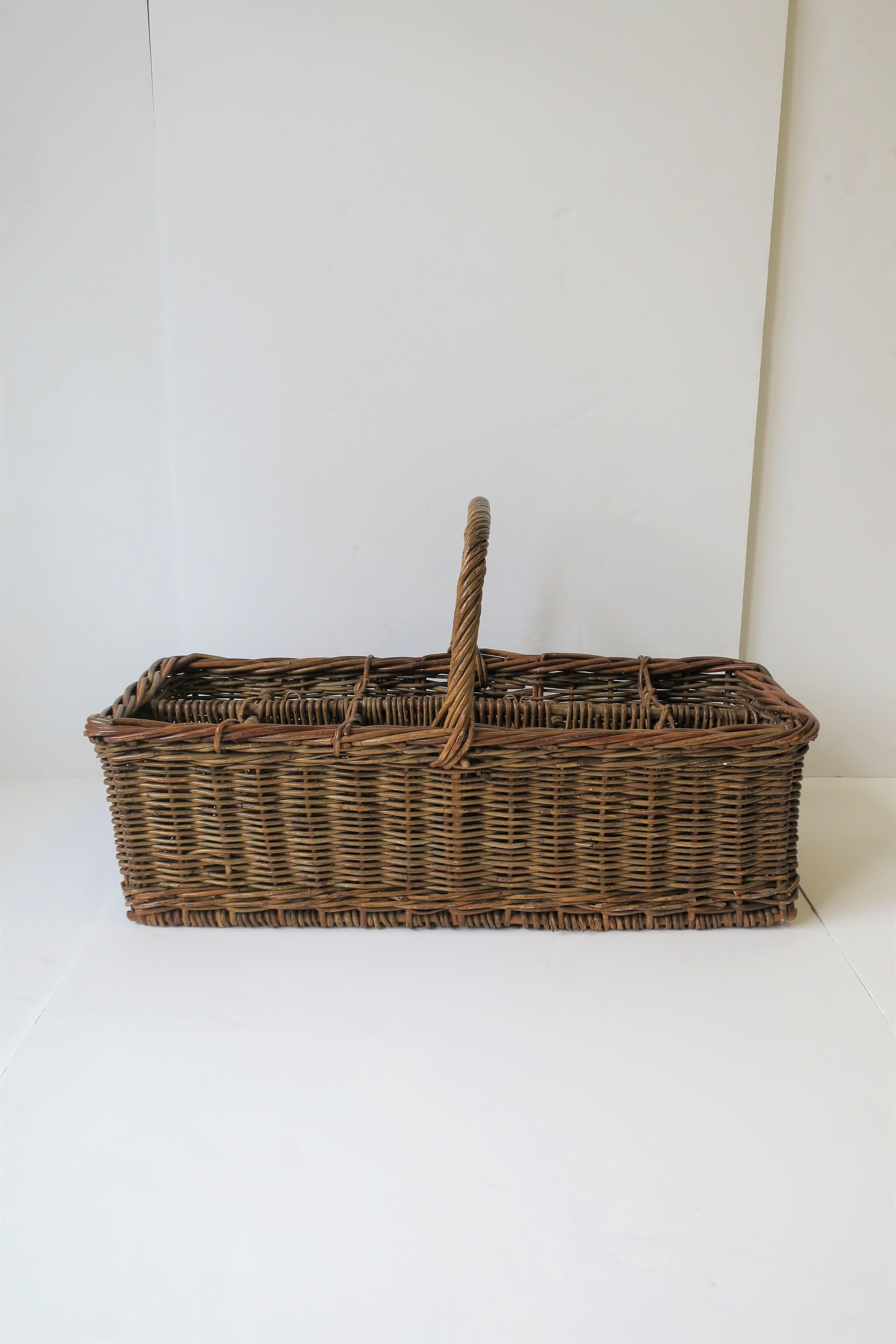 A substantial vintage wicker wine bottle holder basket with handle. 

Piece measures: 
29.5 in. W x 12 in. D x 16.75 in. H to top of handle.

  