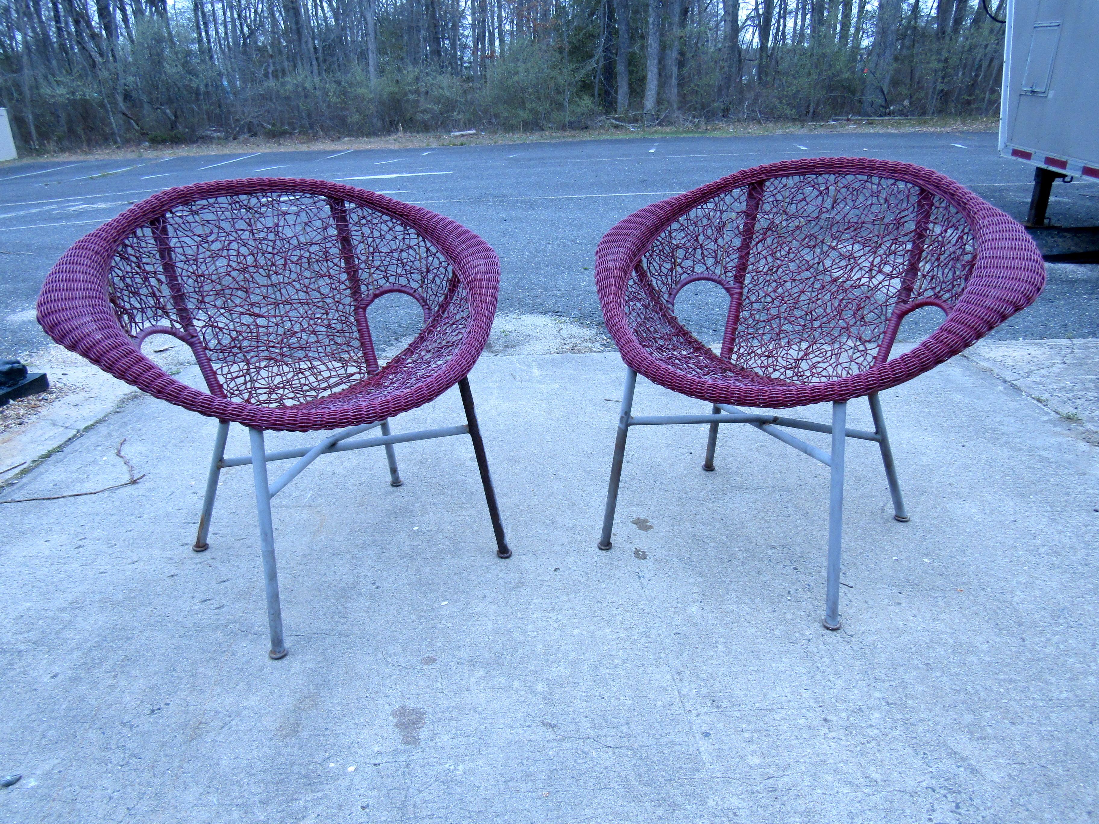 Vintage Wicker wingback lounge chairs in a mid century style featuring comfortable armrests and metal x-frame bases. Please confirm item location (NY or NJ).