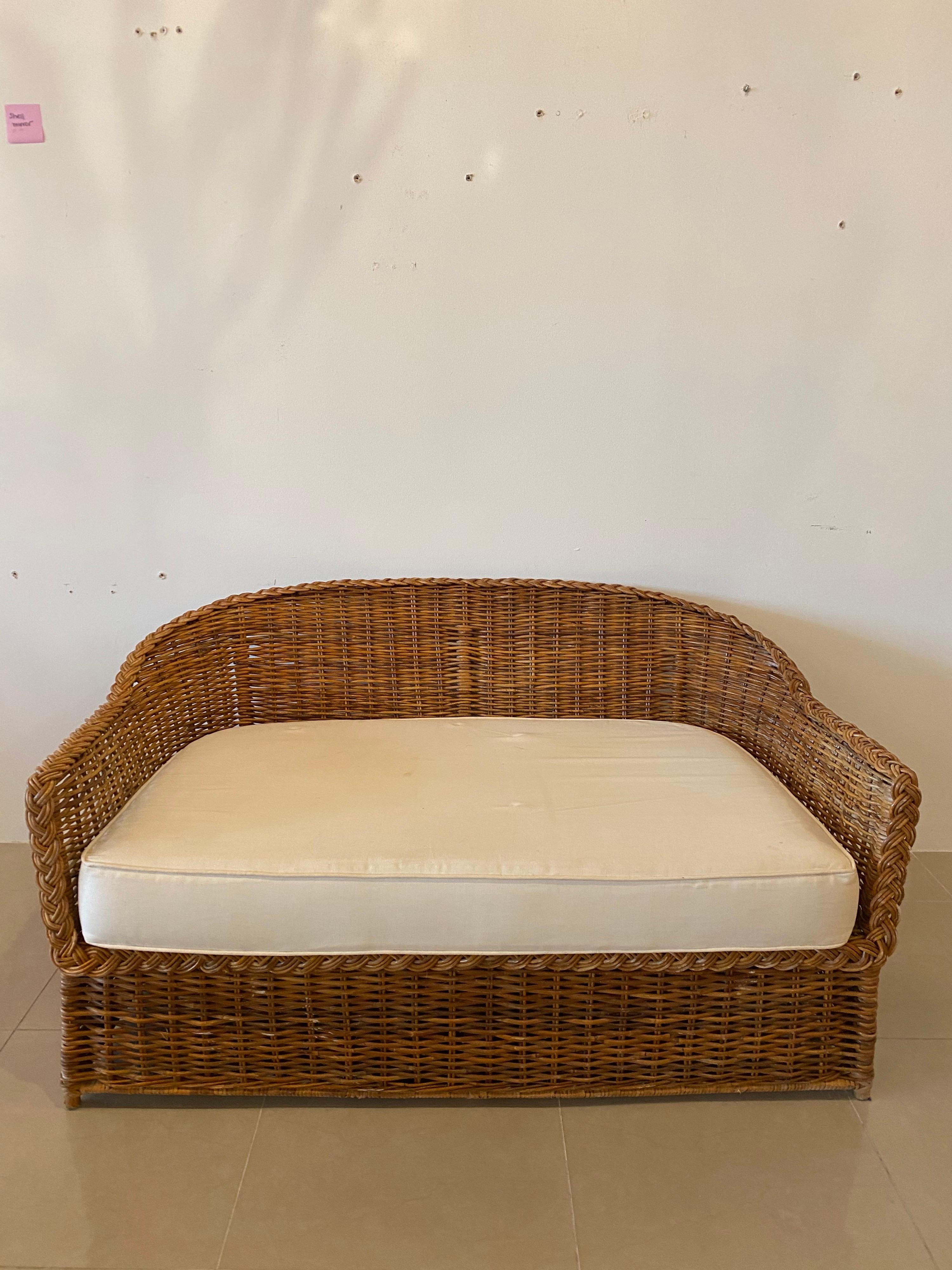 
Lovely vintage braided wicker loveseat by Wicker Works. Matching sofa available separately. Various end and matching coffee tables also available. This comes with the bottom cushion. The cushion is original and needs new upholstery. No back