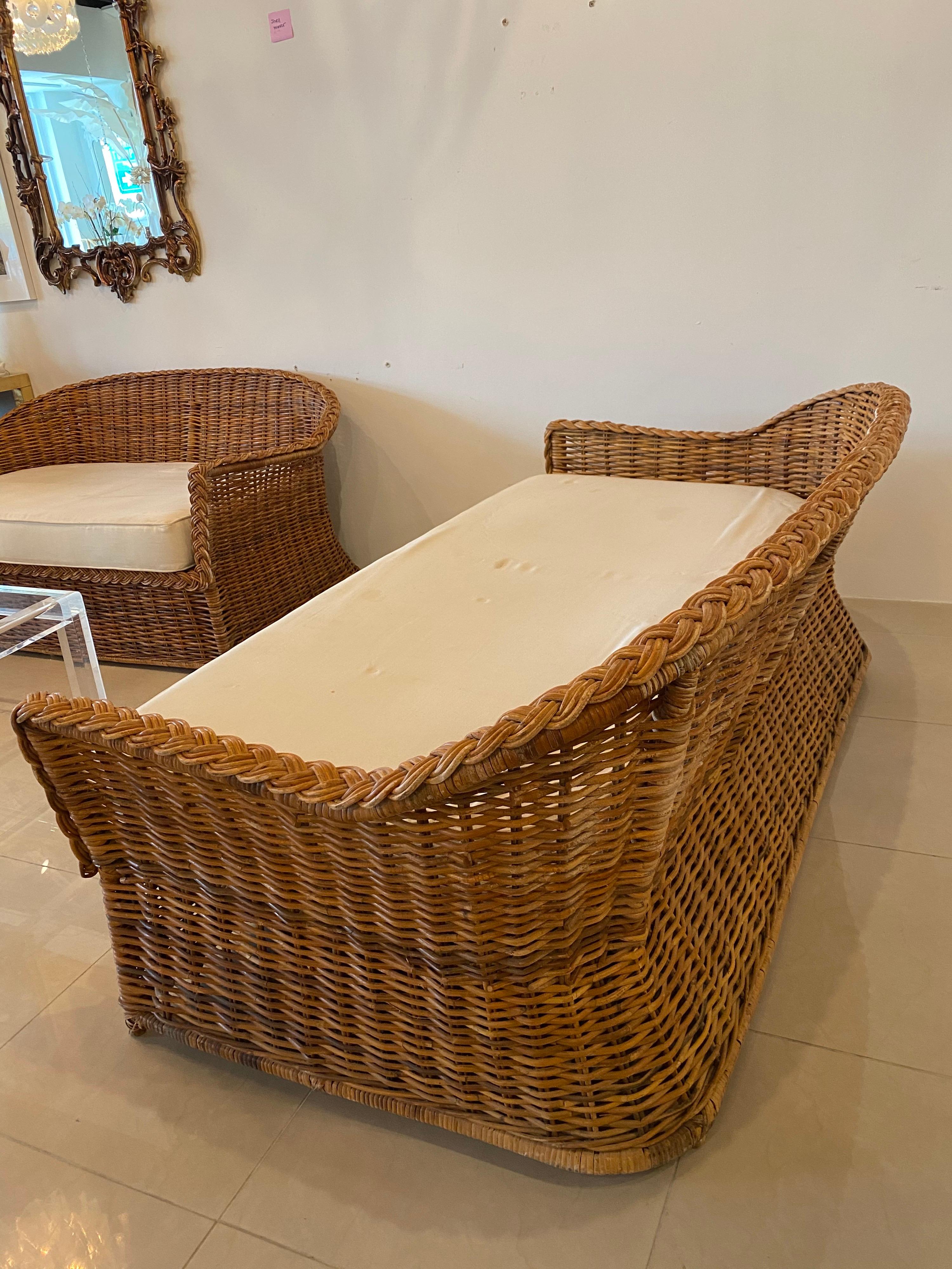 Lovely vintage braided wicker sofa by Wicker Works. Matching loveseat available separately. Various end and matching coffee tables also available. This comes with the bottom cushion. The cushion is original and needs new upholstery. No back
