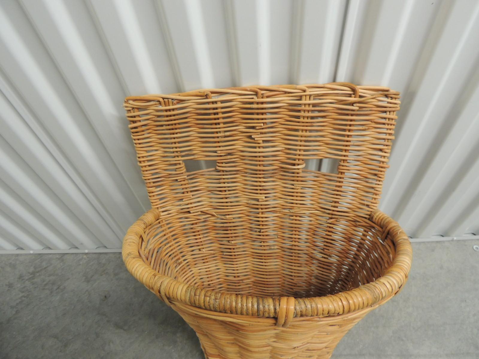 Vintage wicker and bamboo woven wall basket or umbrella stand.
Oval conical shape wall basket with openings woven in the back to hang on the wall.
Size: 16 x 12 x 24 H.