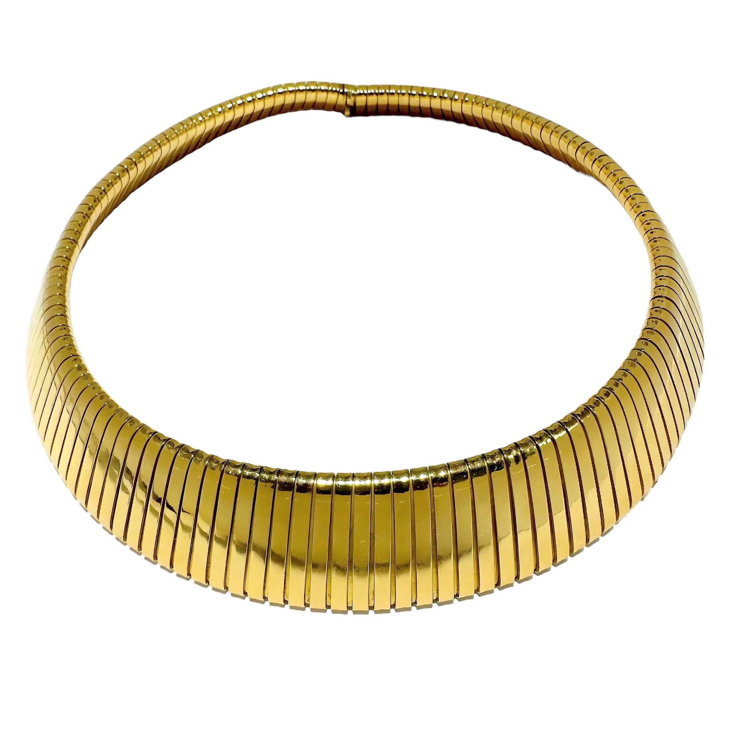 This imposing mid-20th Century Italian wide tubogas choker necklace measures a full 7/8 of an inch at it's center and tapers slightly to 9/16 inches at the rear.  It is stamped 750, indicating 18K gold and bears a workshop mark for items made in