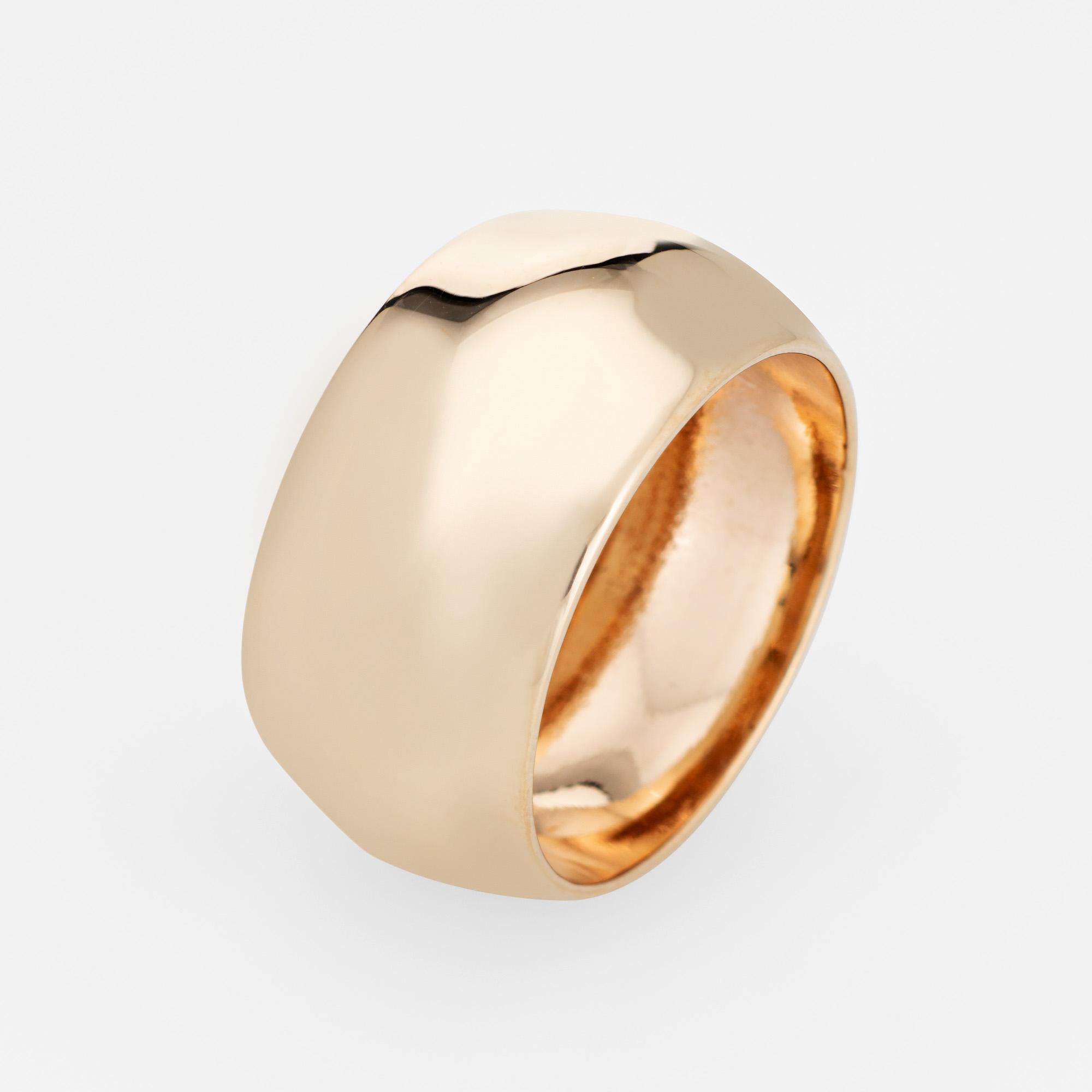 Stylish vintage wide band (circa 1980s) crafted in 14 karat yellow gold. 

The unique wide 10mm (0.39 inches) ring features a raised ridge to the center of the band. Great worn alone or stacked with your fine jewelry from any era.  

The ring is in
