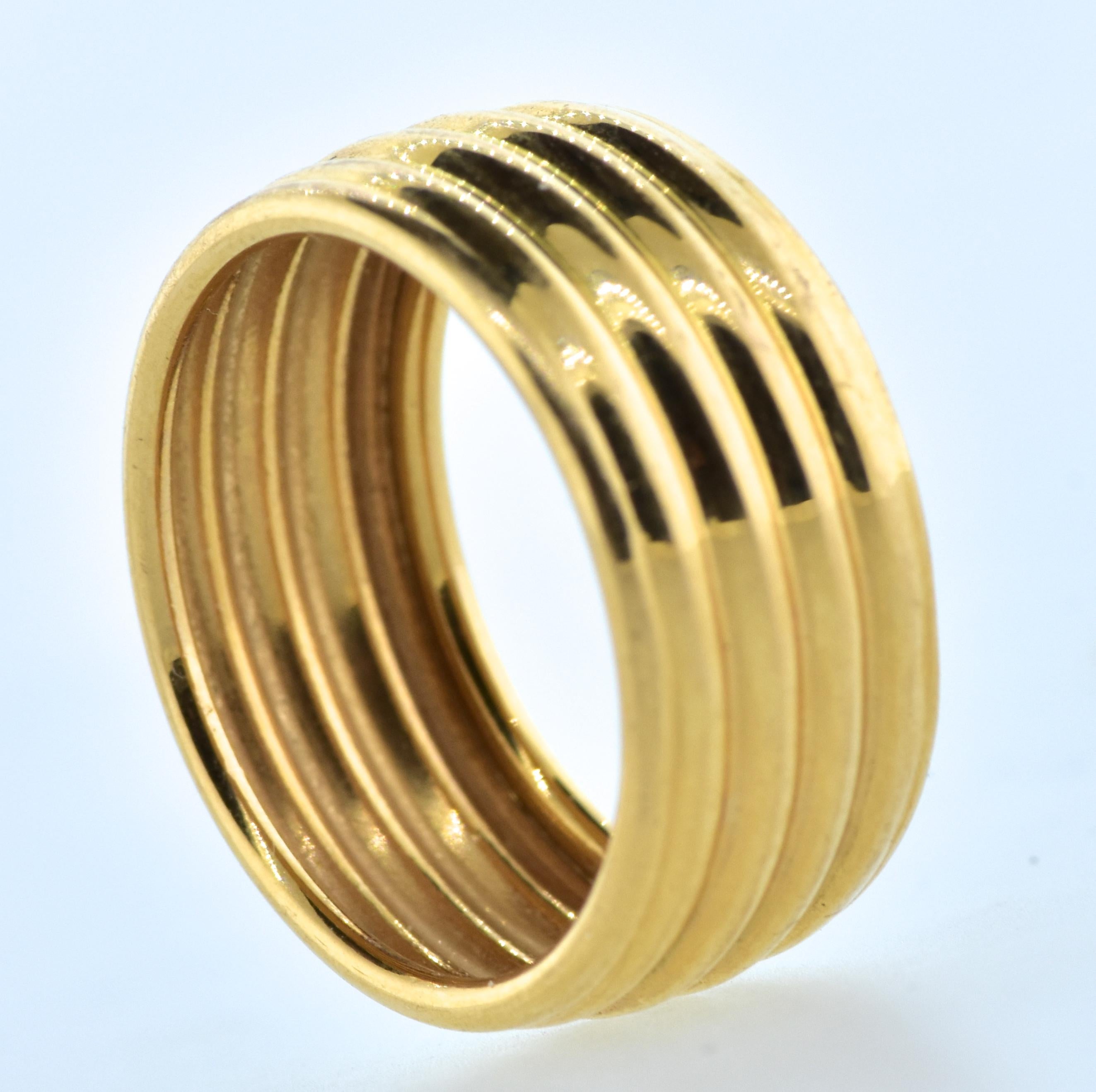 18K wide gold 4-tier band, unusual in design. This wide gold band weighs 2.12 grams and is a size 4.8 and can be sized easily.  A classic and bold statement for the hand, this ring is well made and in fine condition.