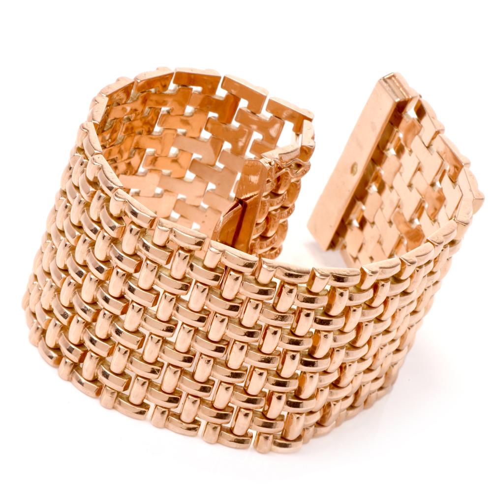 This fashionable vintage 1960s wide bracelet is crafted in 14Karat rose gold. This bracelet is composed of 9 adjacent rows of flexible “T” shaped links. Weighing 63.7 grams, measures 7.50 inches around the wrist and 37mm wide. Secures with a sturdy
