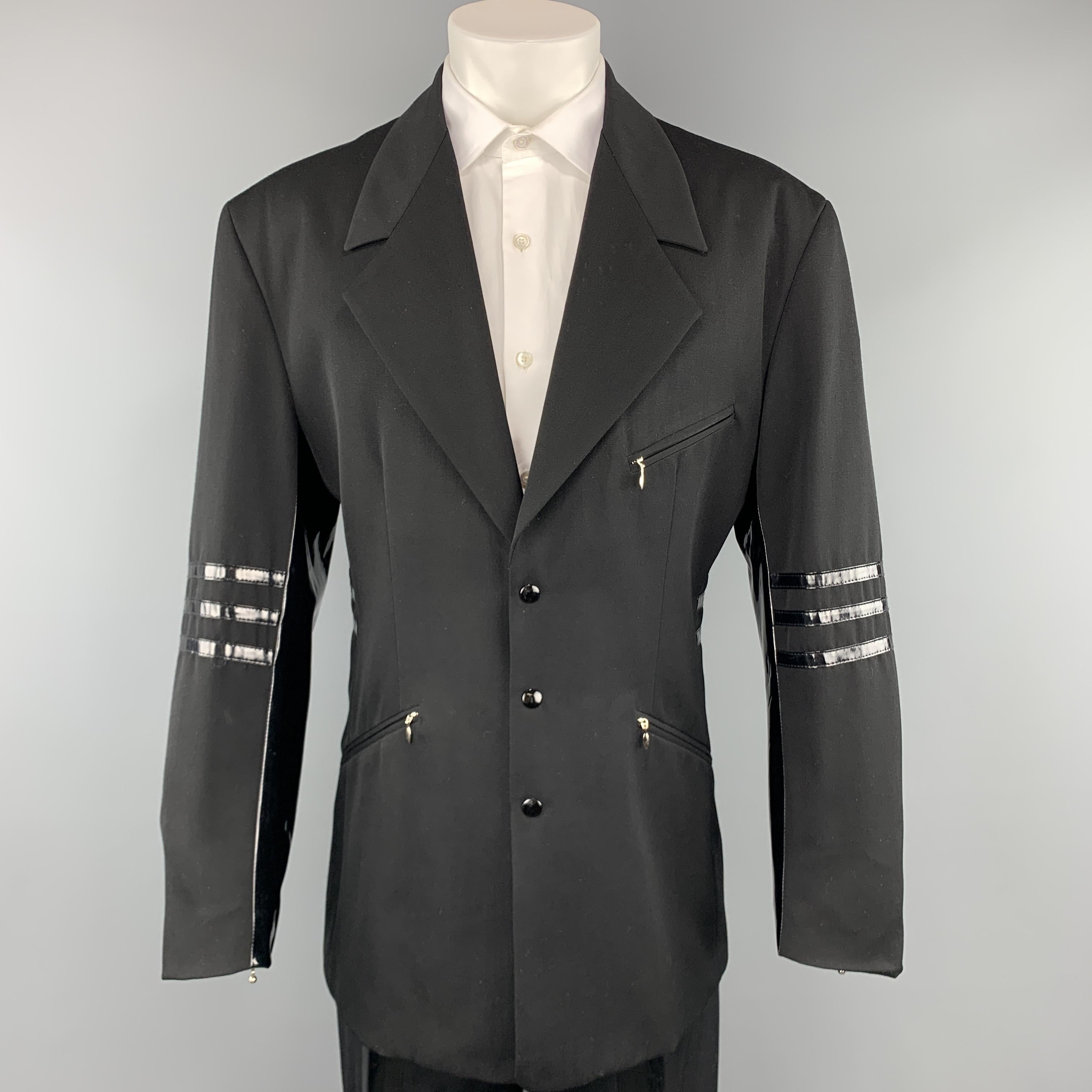 Vintage WILLIAM B suit comes in black wool twill and includes a single breasted, three snap closure sport coat with a downward peak lapel, slanted zip pockets, vinyl stripes and matching flat front vinyl stripe panel flat front trousers. 

Very Good