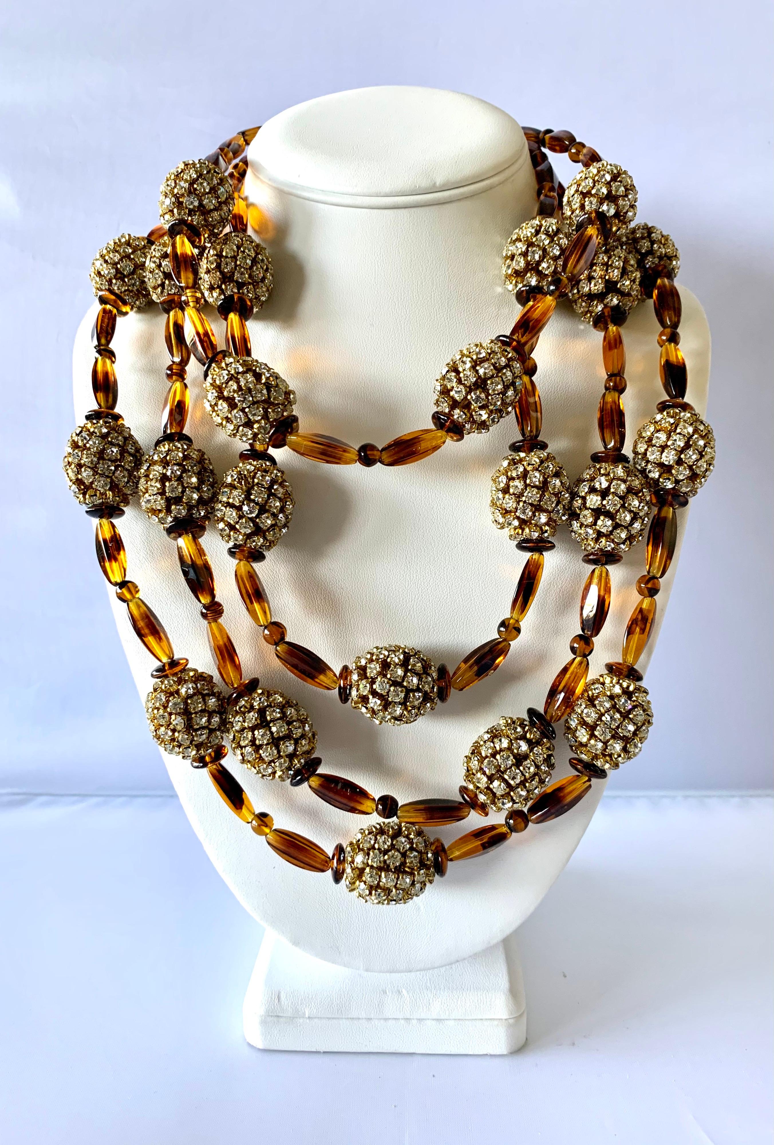 Vintage unique multi-strand statement necklace by William de Lillo for William de Lillo LTD NY. Comprised of four strands of German faux tortoise elongated glass beads which are accented by large gilt metal oval diamante beads - the attention to