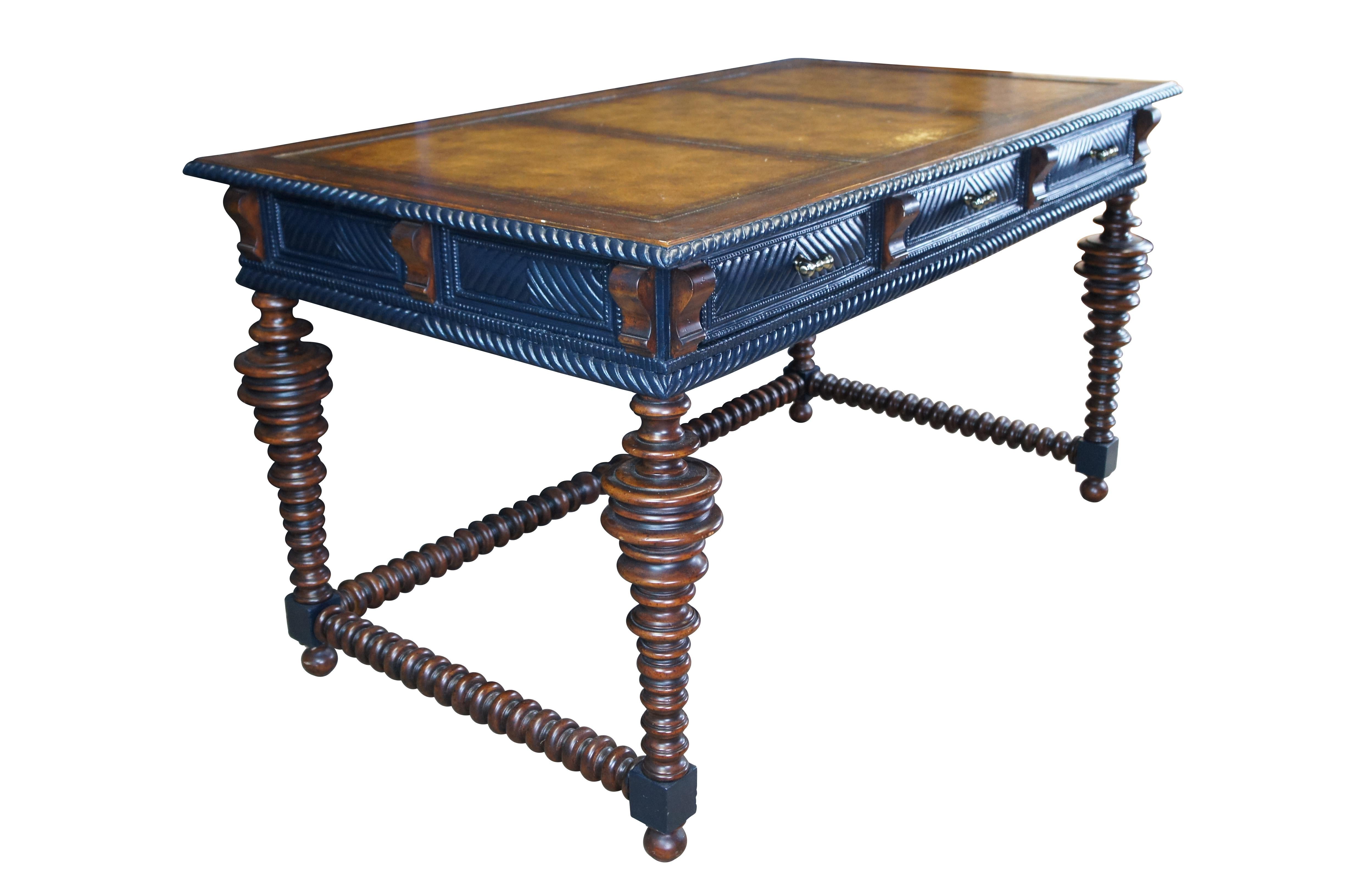 Vintage William & Mary style / Spanish / Colonial / Renaissance Revival library desk featuring a mahogany finish with ribbed and stacked design supporting a tooled leather top with three frieze drawers.

Dimensions:
56