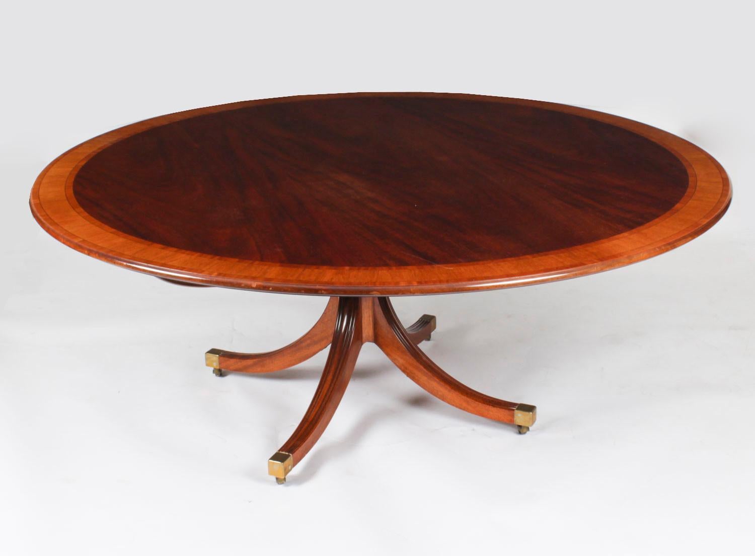This is a  fabulous vintage Regency Revival dining table, made  by the master cabinet maker William Tillman in the 1980s and bearing his label. 

The beautiful circular dining table has a tilt top and is made of  flame mahogany with satinwood