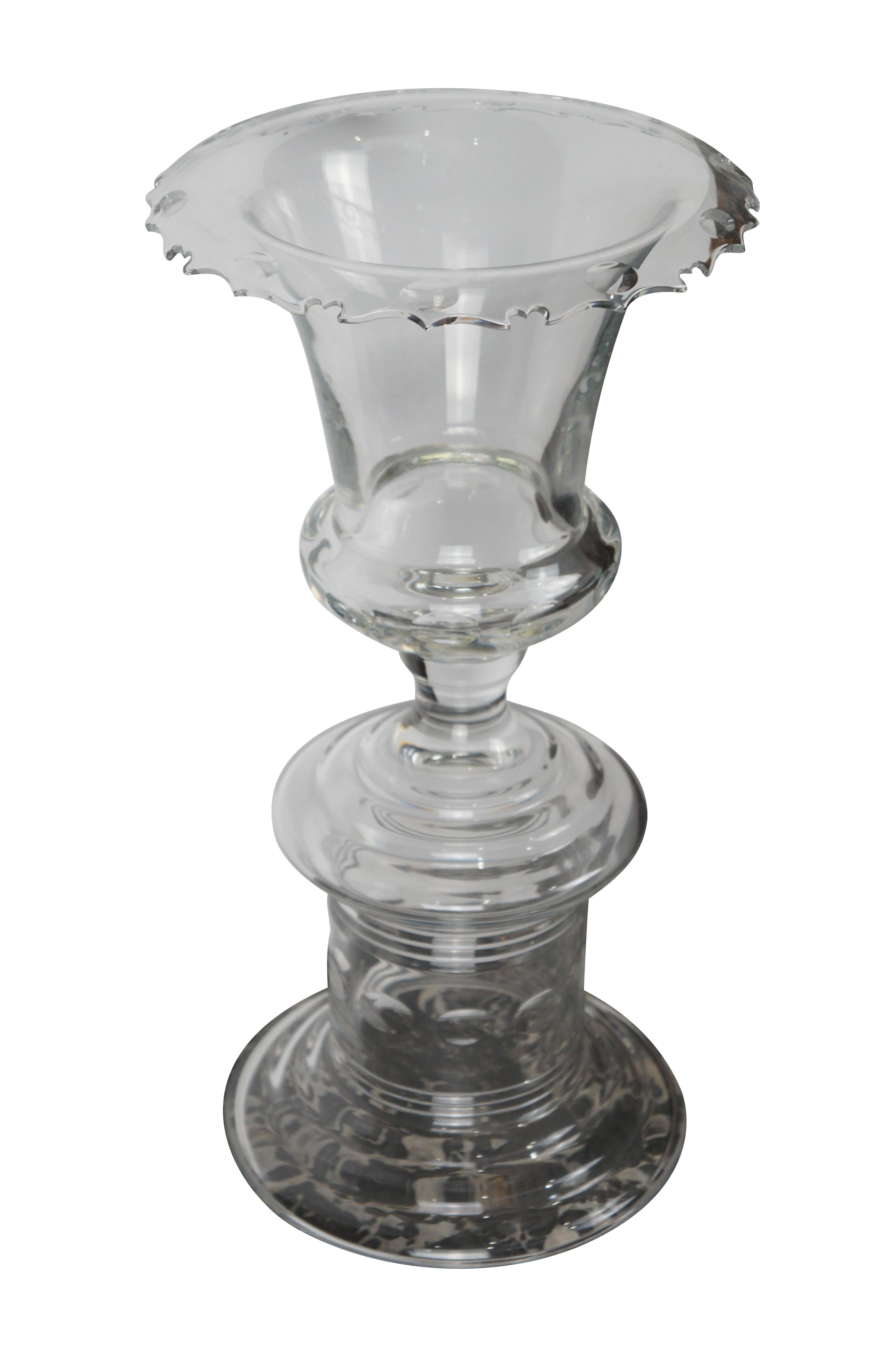 Large and impressive crystal vase from the Jenkins Collection by William Yeoward. Features a trophy urn / flower vase with cut coin dot patterns and ribbed accents over a tired footed base. The vase has a flared mouth with sawtooth cut design. This
