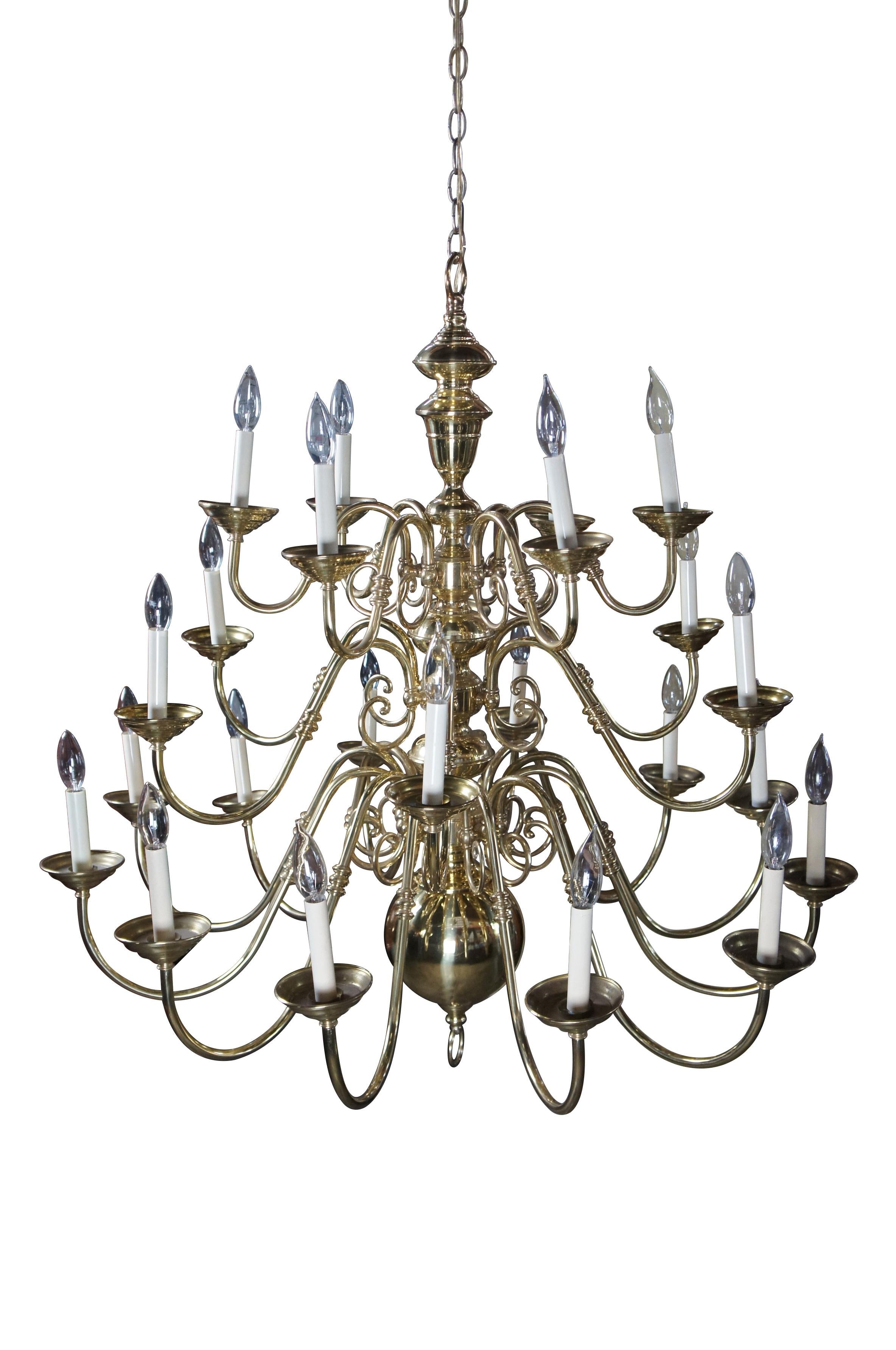 Vintage Williamsburg style chandelier featuring stacked orbs with ring drop finial and twenty four serpentine candlestick / candle lights set on three tiers. 

Dimensions:
40