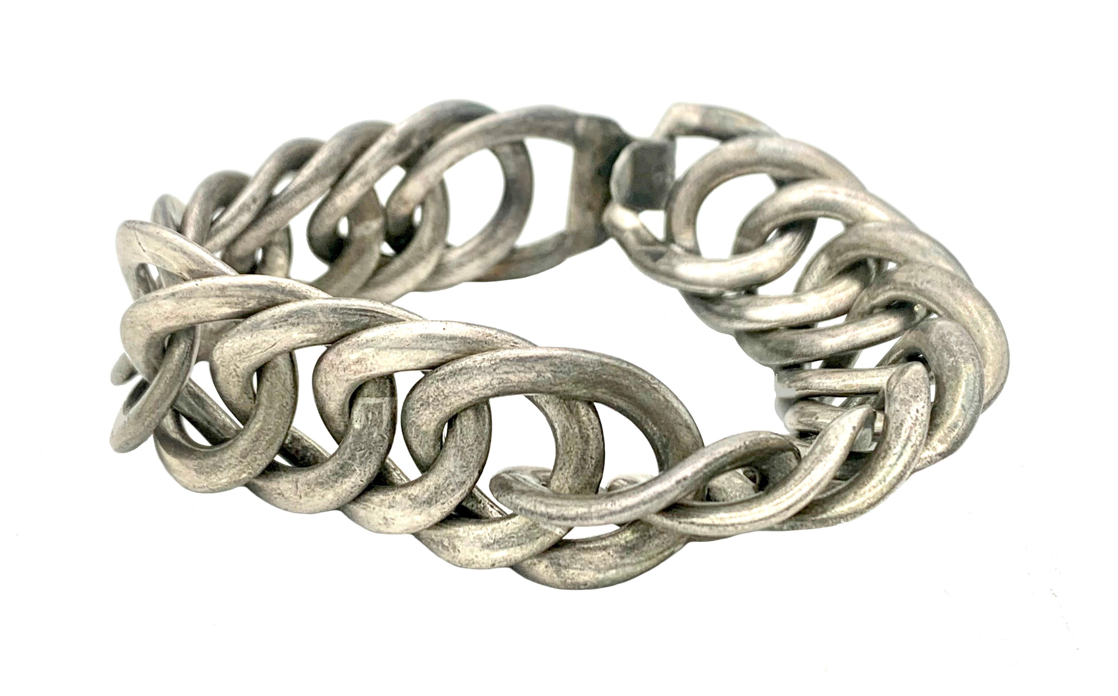 This solid flexible link bracelet was created by William Spratling in the Mid-20th century in Mexico.
It is made out of sterling silver and carries full hallmarks and makers mark. The makers mark was in use from 1940-1946 ca.