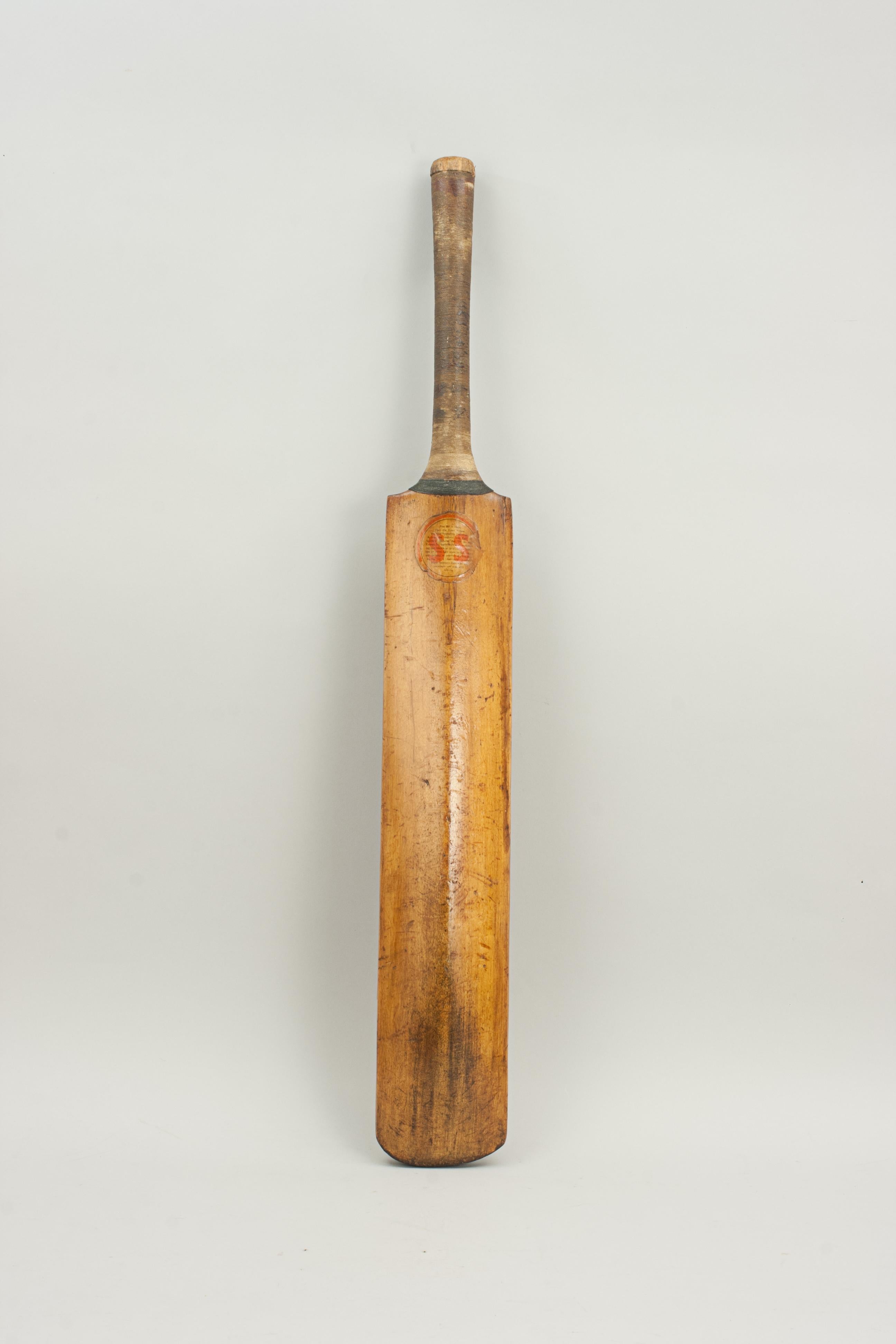 Wellington Cricket bat.
A good willow cricket bat stamped 'TRADE MARK WELLINGTON' with the Wellington trade mark on the shoulders of the bat. The embossing is very faint, there are red ball marks on the blade and the handle whipped. The back of the