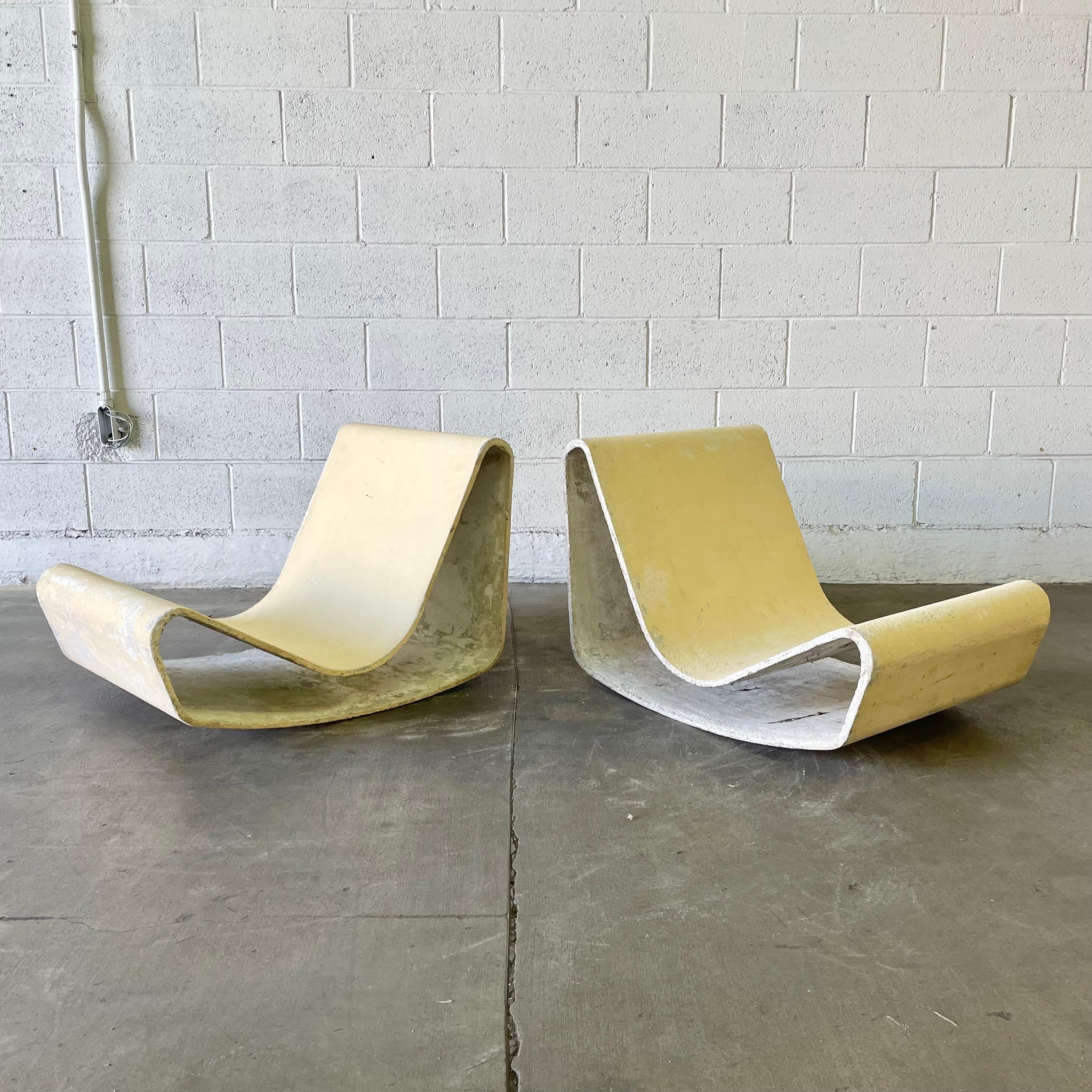 Iconic pair of concrete loop chairs by Willy Guhl.

This pair of chairs were designed by Willy Guhl in 1954 after Guhl watched as the Eternit panels left a machine at the Eternit factory in Niederurnen. With a beautiful pastel yellow patina these